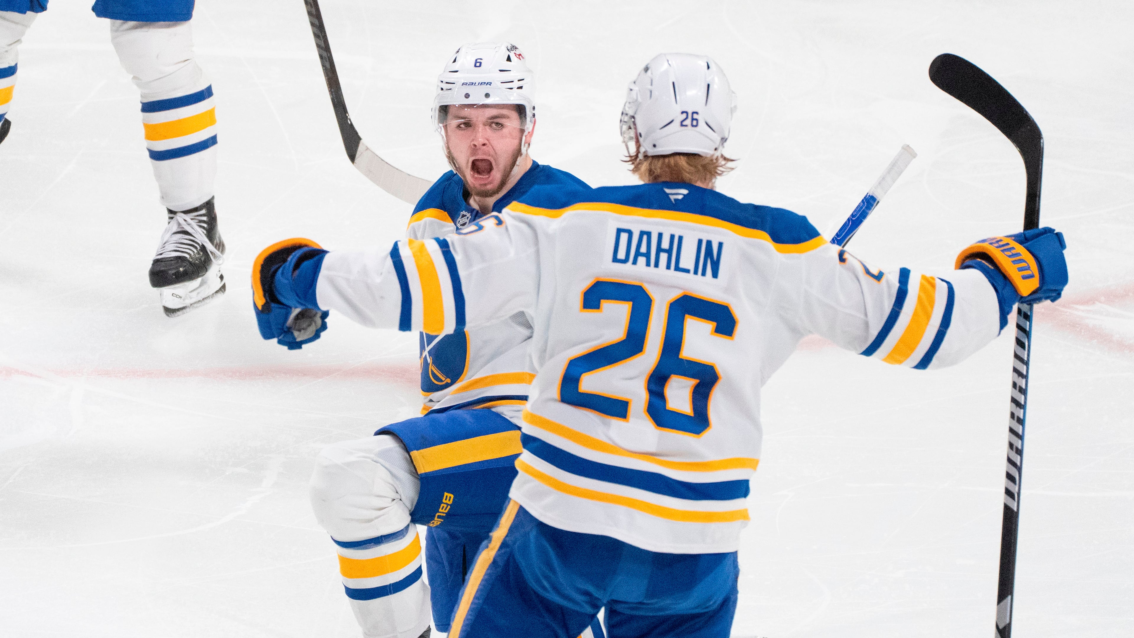 Buffalo Sabres' Zach Benson (6) celebrates his goal over Montreal Canadiens with teammate Rasmus Dahlin (26) during third period, second round, game 4, NHL playoff action in Montreal on Tuesday, May 12, 2026. (Christinne Muschi/The Canadian Press via AP)