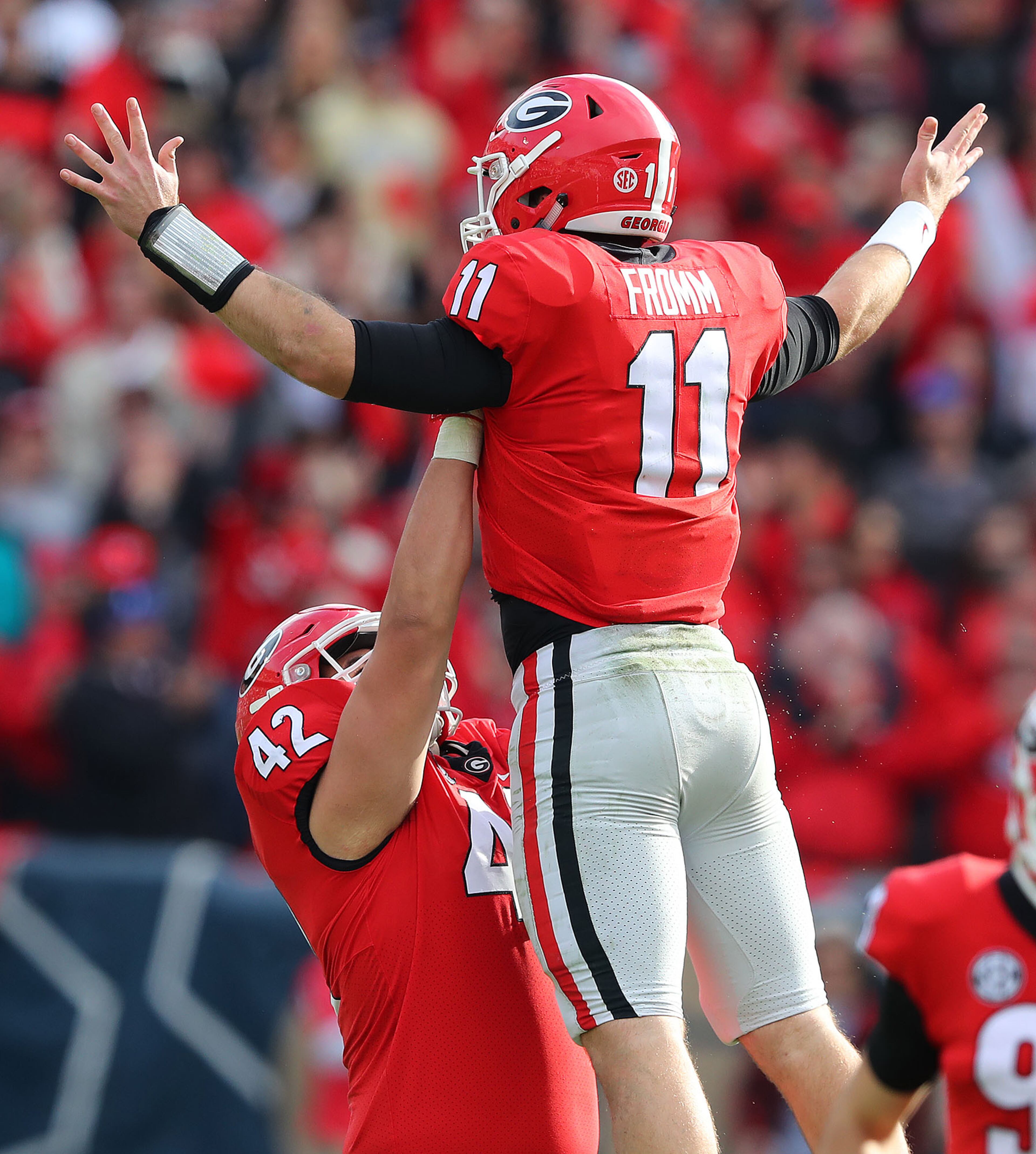 November 25, 2017 Atlanta: Georgia quarterback Jake Fromm gets a hoist from Aulden Bynum celebrating his touchdown pass to wide receiver Ahkil Crumpton to take a 38-7 lead over Georgia Tech during the fourth quarter in a NCAA college football game on Saturday, November 25, 2017, in Atlanta. Georgia beat Georgia Tech 38-7. Curtis Compton/ccompton@ajc.com