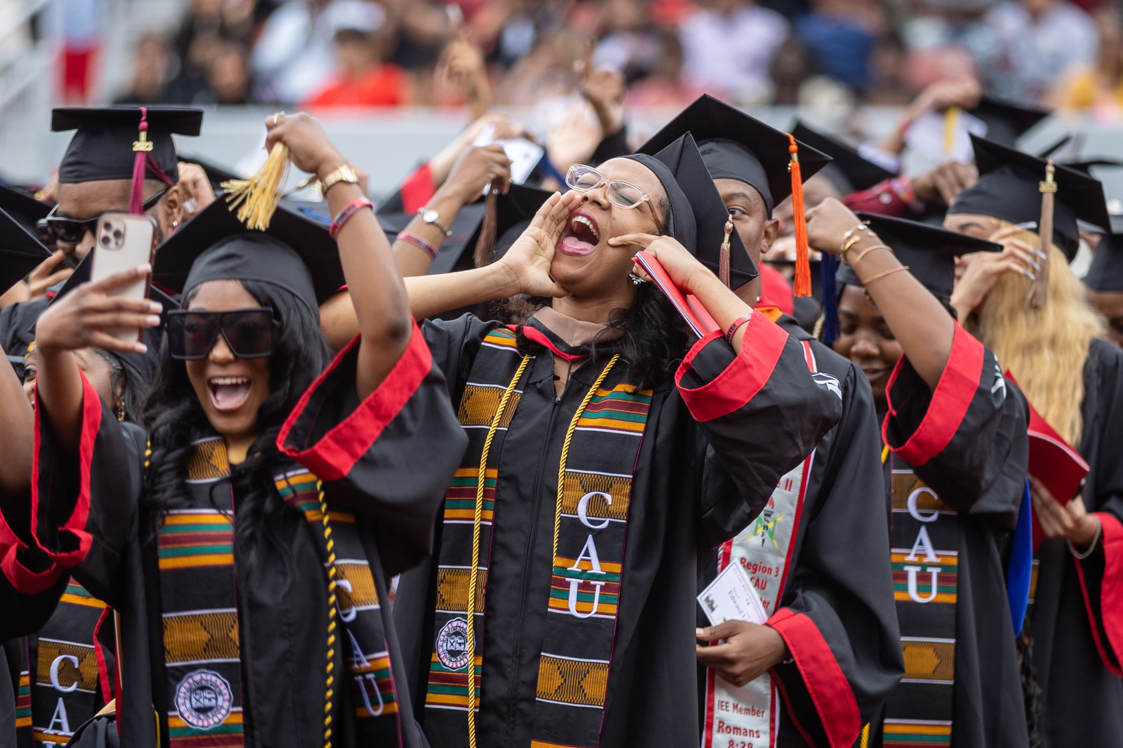 Graduates celebrate during Clark Atlanta University's commencement ceremony in Panther Stadium Saturday, May 20, 2023. (Steve Schaefer/steve.schaefer@ajc.com)