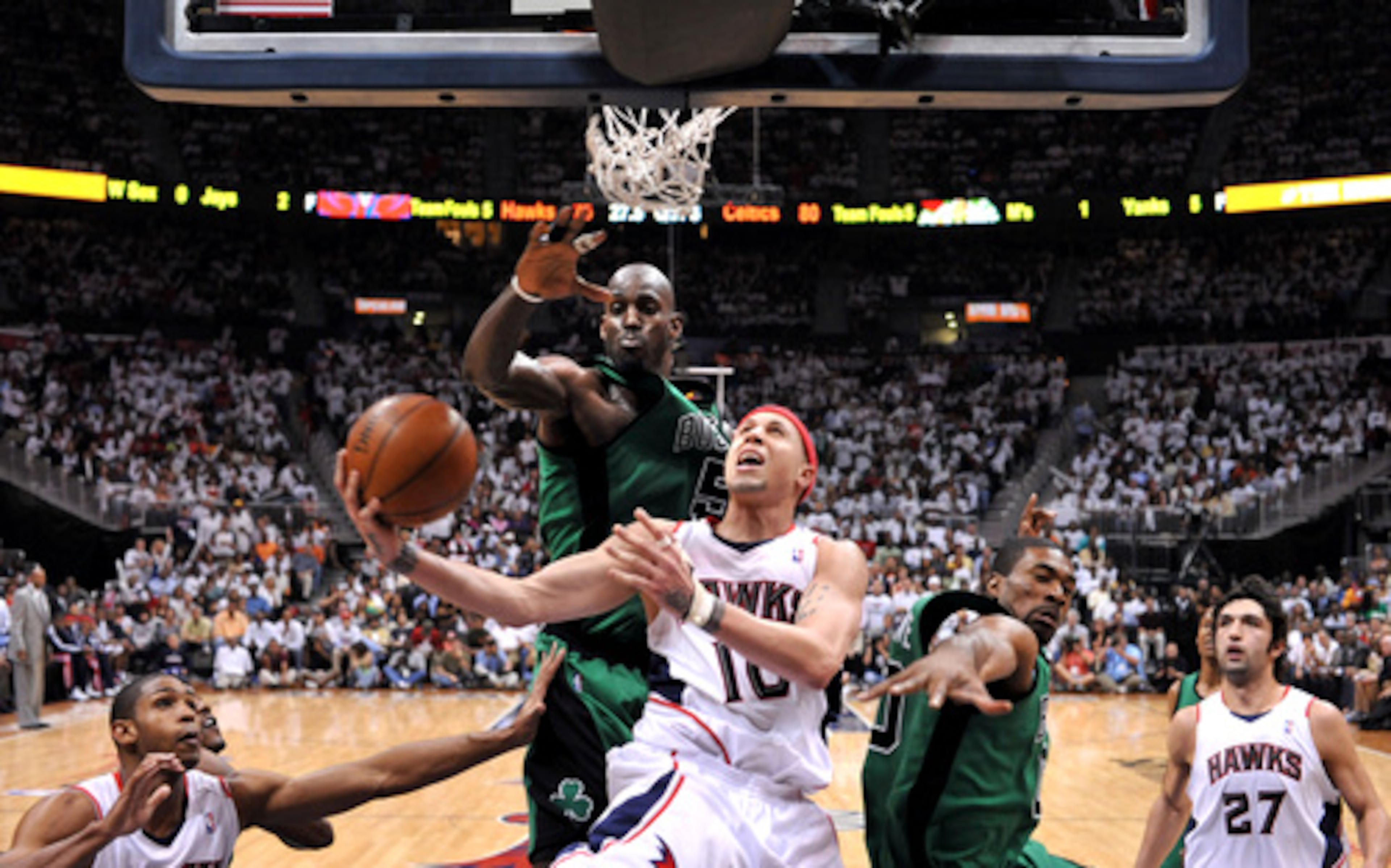 Guard Mike Bibby drives to the basket against Celtics' Kevin Garnett for two of his 17 points. Six Hawks scored in double figures.