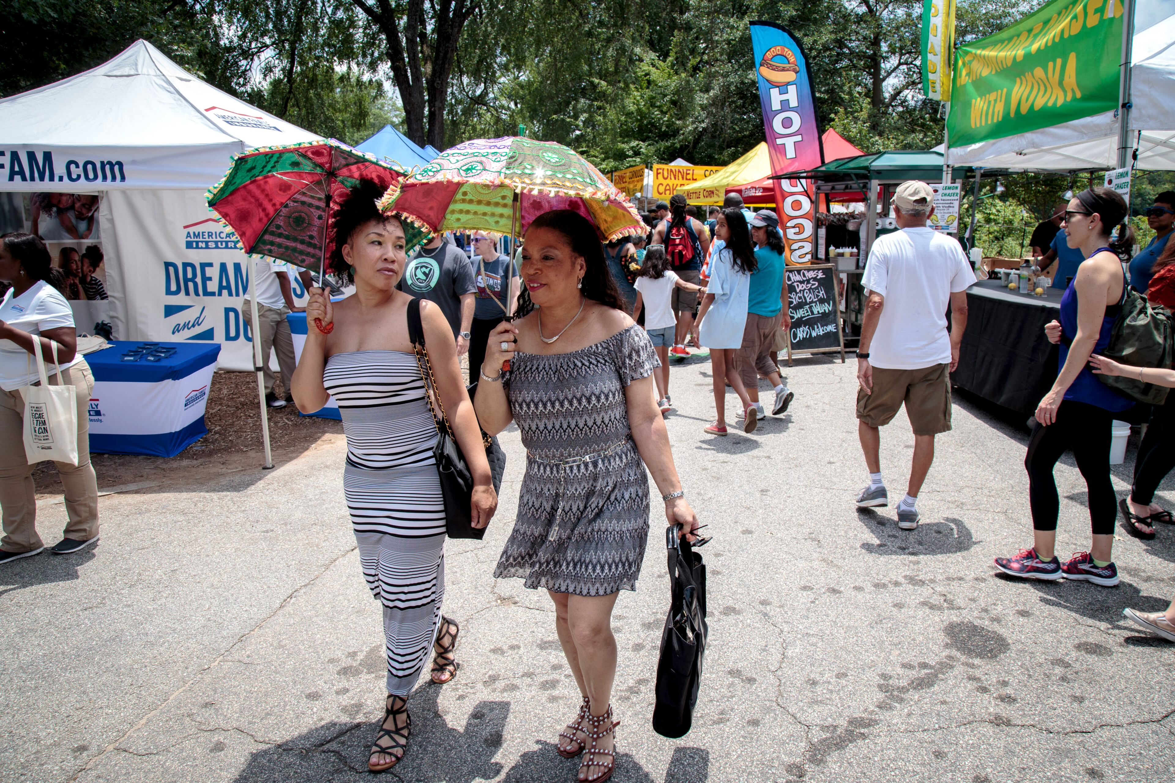 Sheryl Royster (L) and Barbara Swancy (R) make their way through the artist market during the Atlanta Jazz Festival in Piedmont Park Saturday, May 27, 2017. This year marks the 40th anniversary of the Atlanta Jazz Festival and is expected to attract more than 100,000 attendees. STEVE SCHAEFER / SPECIAL TO THE AJC