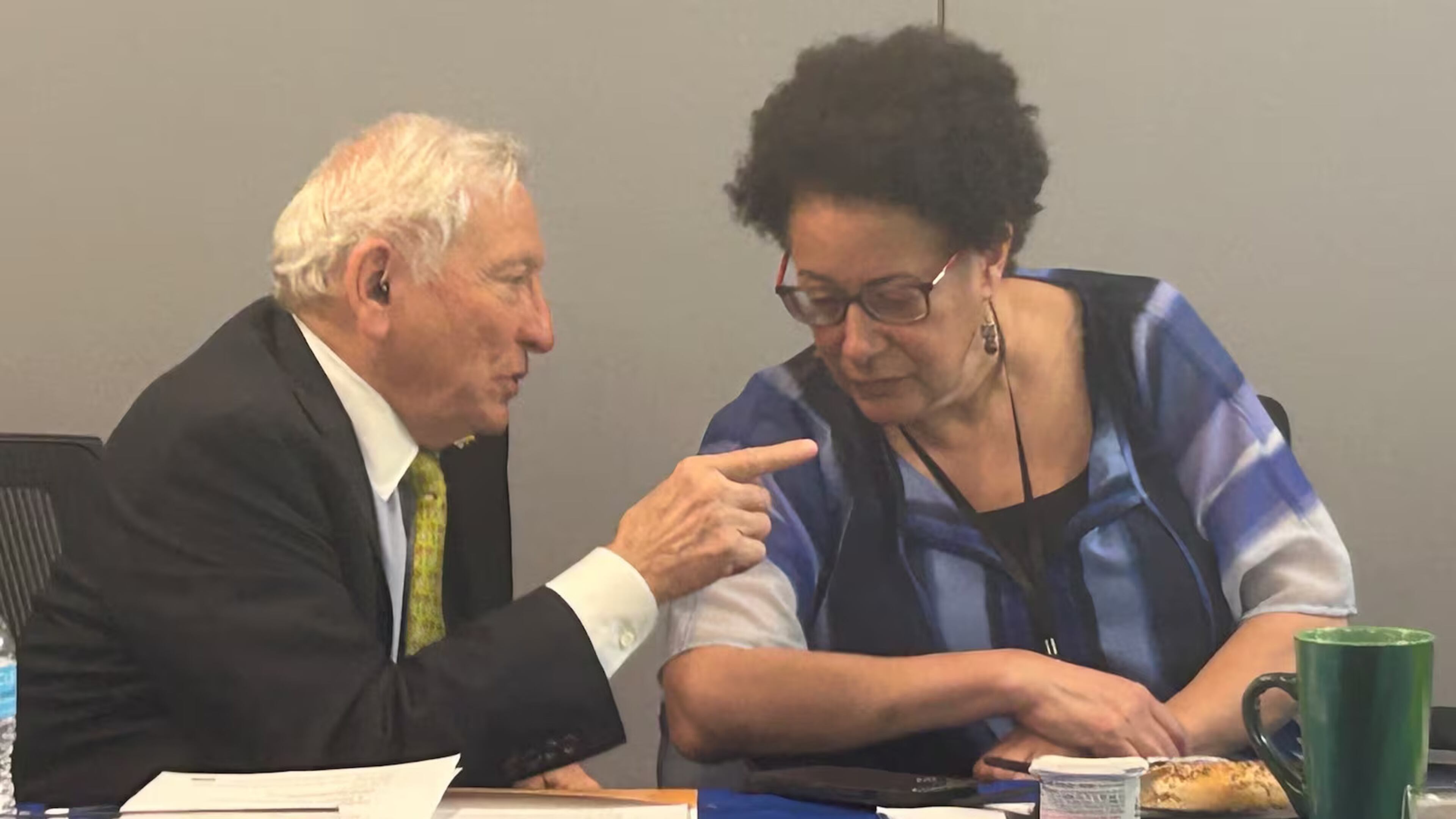 Jack Hardin, left, chairman of the Fulton County Board of Health, speaks with District Health Director Dr. Lynn Paxton at a board meeting on April 23. (Courtesy of Rebecca Grapevine/Healthbeat)