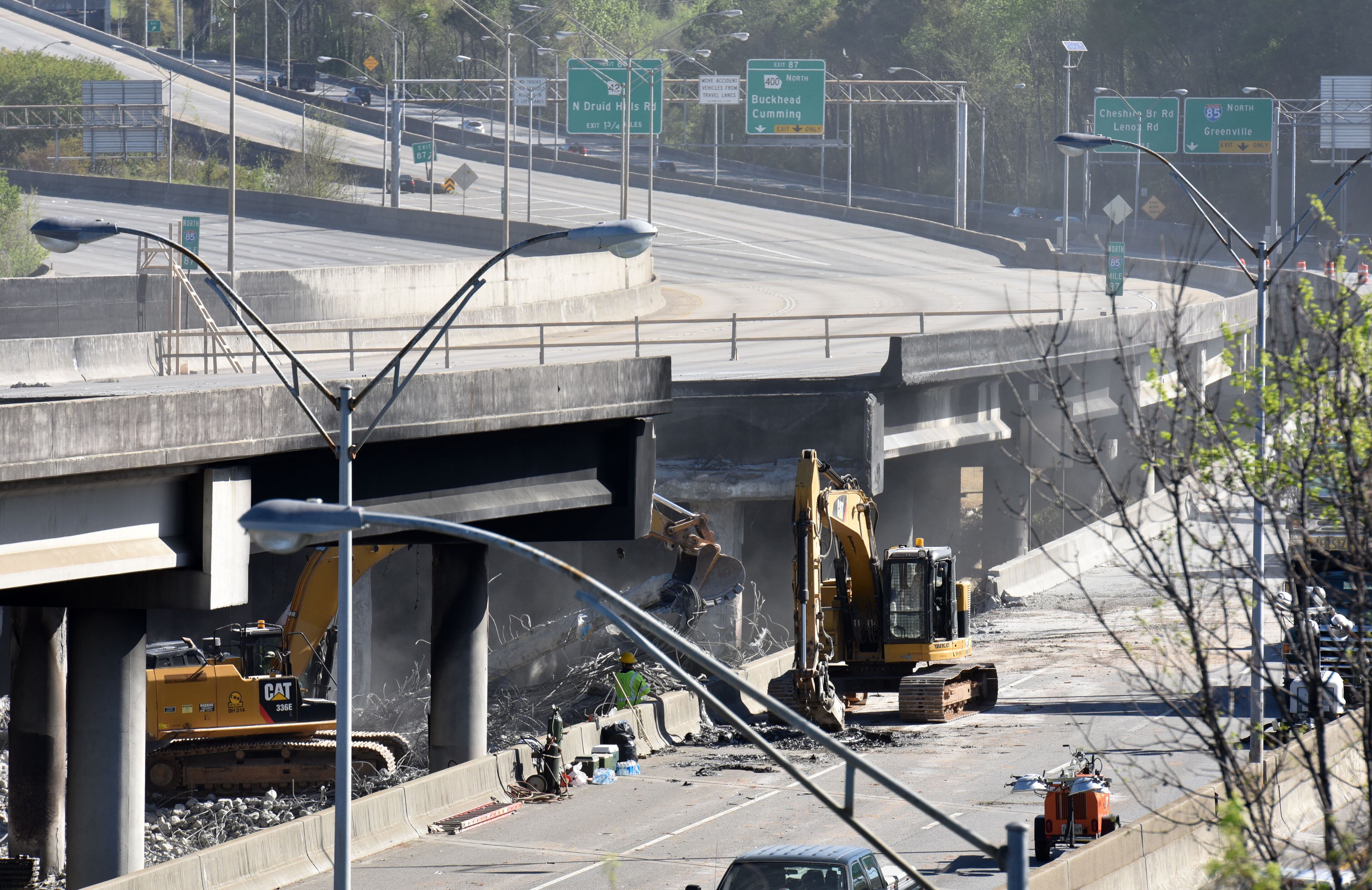 April 1, 2017 Atlanta - Crews work on the site of the bridge collapse on Saturday, April, 2017. Approximately six sections and 700 feet of the roadway â 350 feet northbound and 350 feet southbound â will be removed and replaced, including support columns, according to the Georgia Department of Transportation. The work is expected to take months. HYOSUB SHIN / HSHIN@AJC.COM