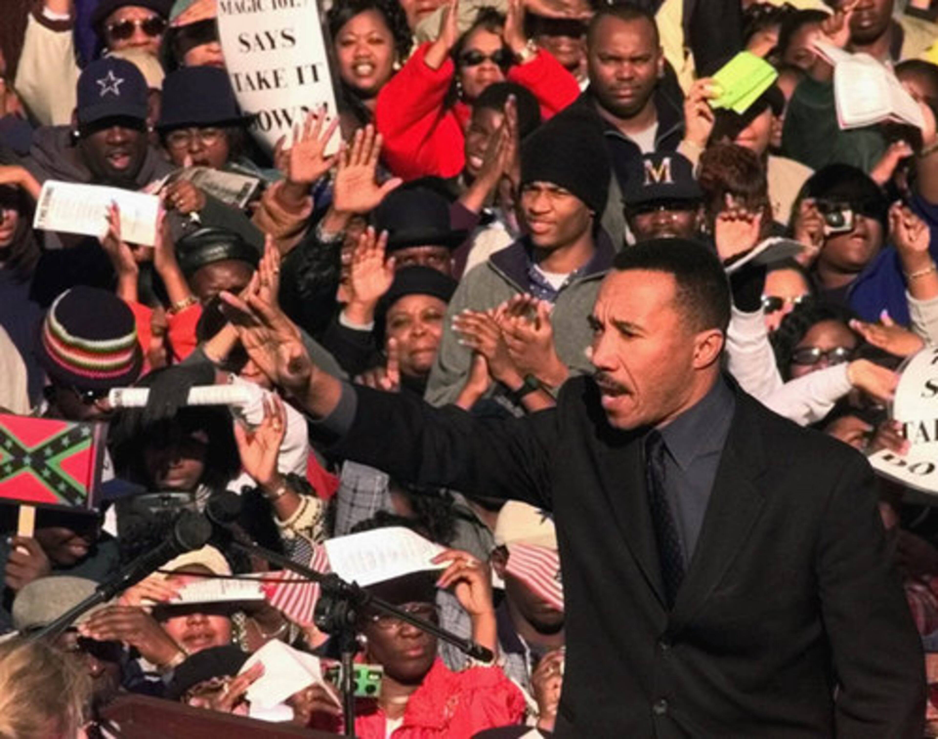 2000: Kweisi Mfume, president and CEO of the NAACP, waves to the crowd during a rally in Columbia, S.C. An estimated 46,000 people gathered to demand the removal of the Confederate flag from the dome of the Statehouse.