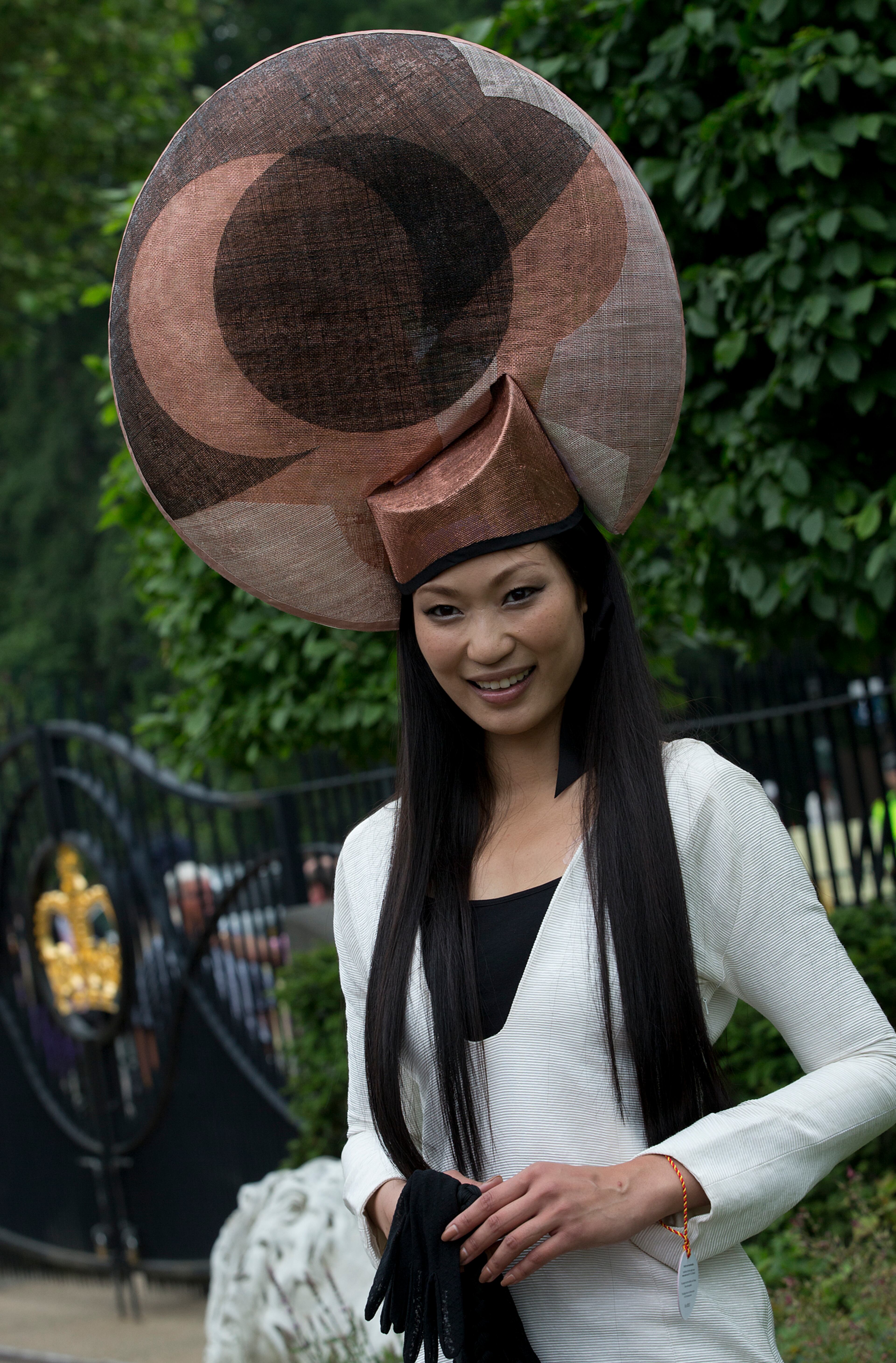 Wei Lin from Taiwan wears an ornate hat on the third day traditionally known as Ladies Day of the Royal Ascot horse race meeting in Ascot, England, Thursday, June 20, 2013. (AP Photo/Alastair Grant)