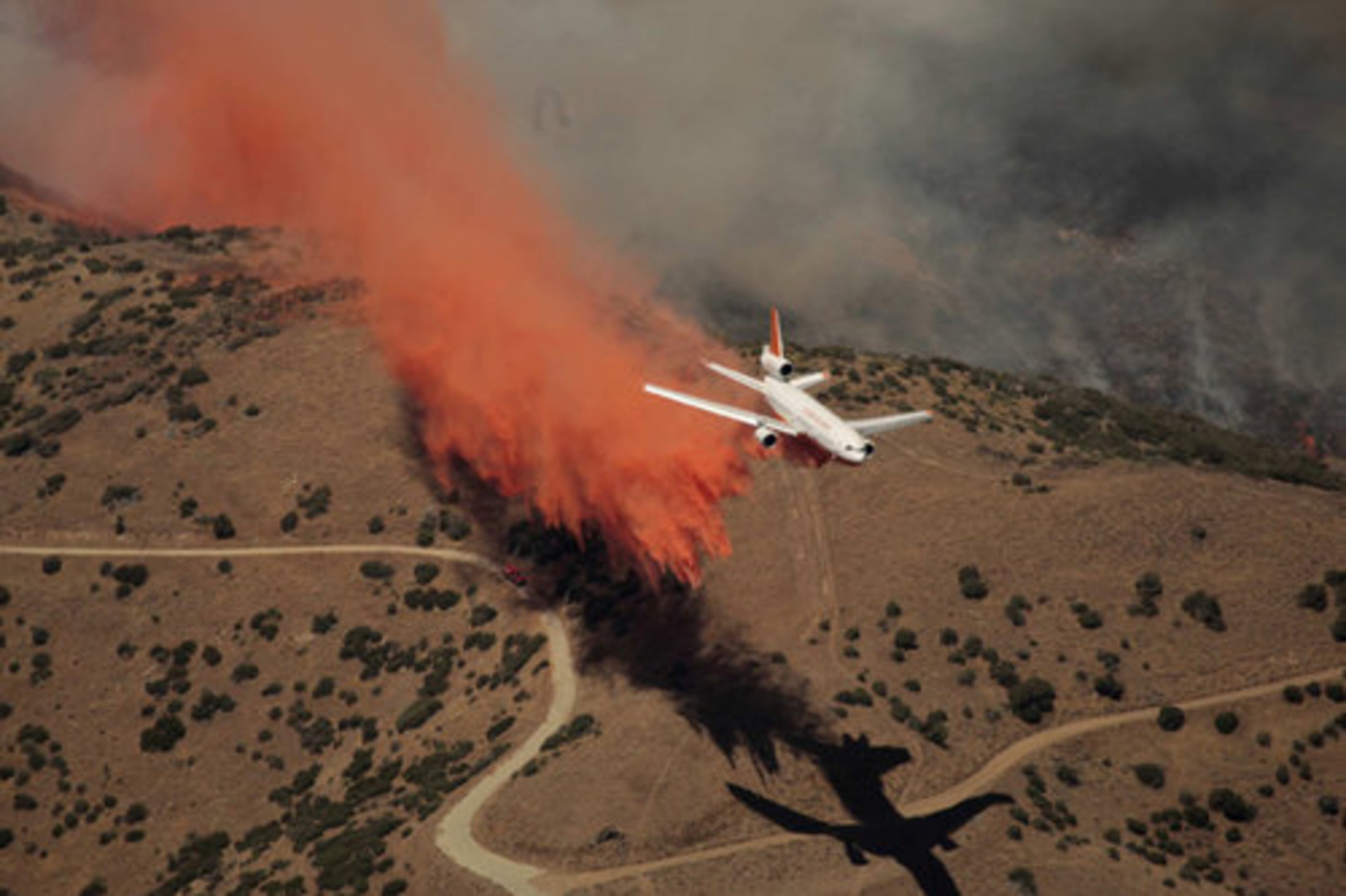 July 27, Palmdale, Calif. - A wildfire smoldered over several days in the high desert north of Los Angeles, spewing plumes of thick smoke that promted air quality warnings as more than 1,300 firefighters worked to contain the blaze. The fire charred more than 20 square miles of brush in the Antelope Valley, threatening hundreds of homes in the 139,000 community.