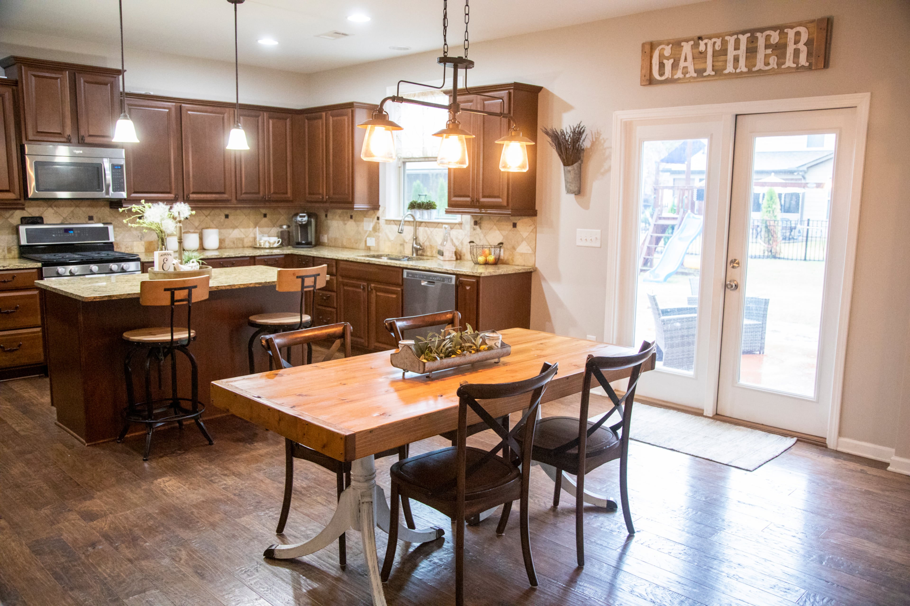 The open kitchen has room for both an island with stools, and the custom kitchen table is by Southern Merle Woodworks. Leah Elliott got into DIY projects by making signs before trying other projects. "Start with something simple," she said.