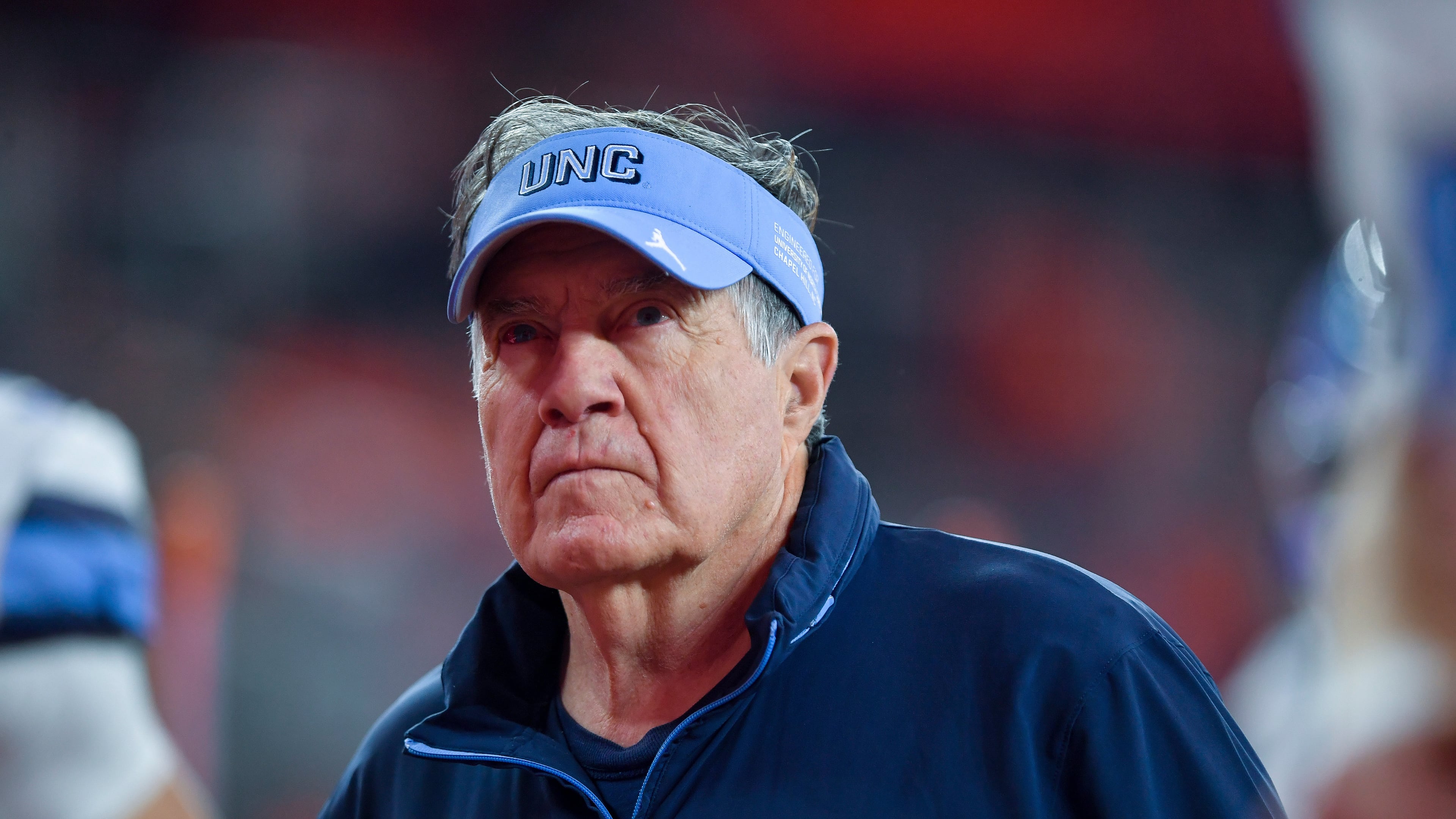 FILE - North Carolina head coach Bill Belichick walks on the field before an NCAA college football game against Syracuse, Oct. 31, 2025, in Syracuse, N.Y. (AP Photo/Adrian Kraus, File)