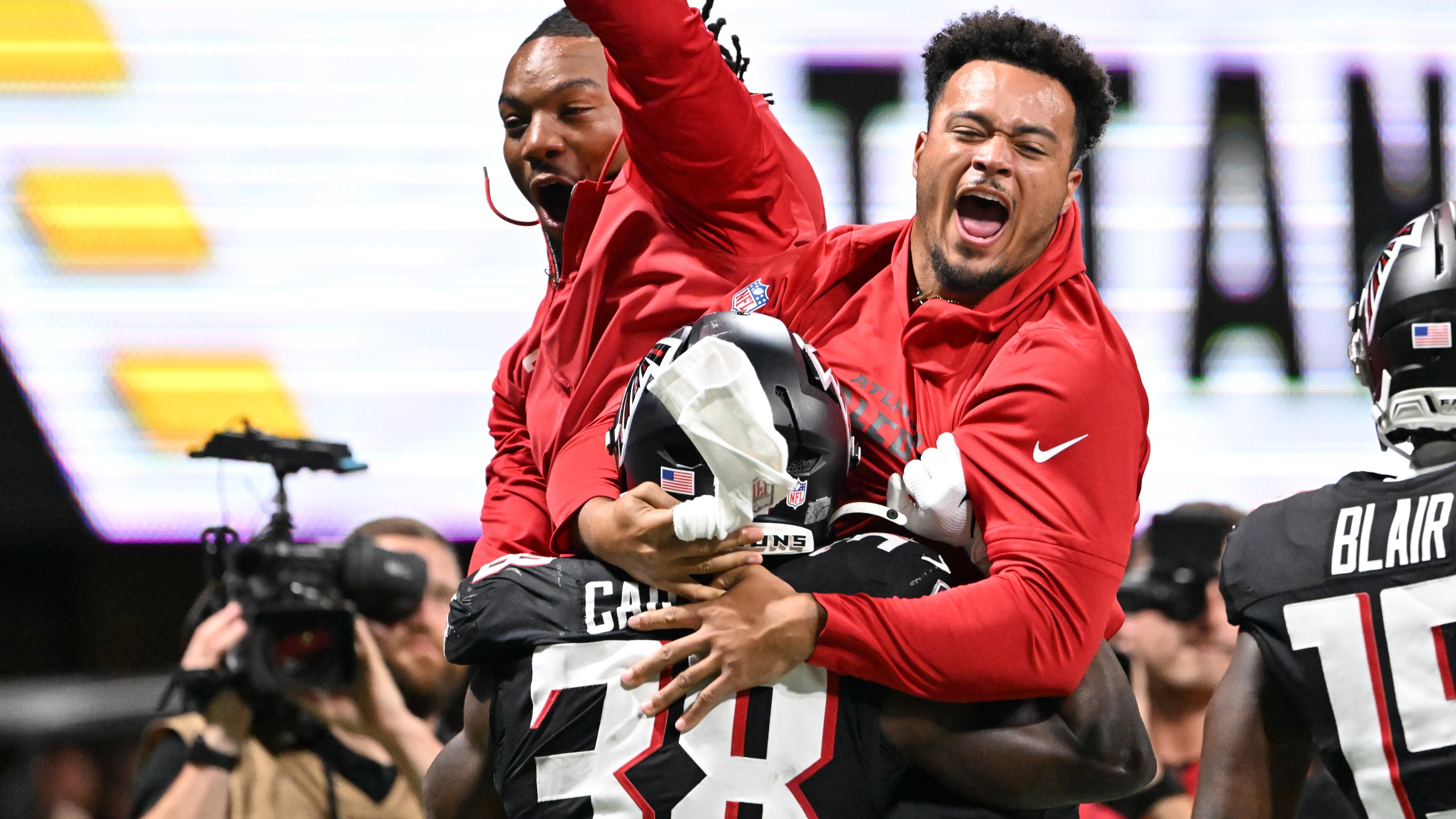 Falcons running back Nathan Carter celebrates with teammates after scoring a touchdown against the Tennessee Titans during an NFL preseason game at Mercedes-Benz Stadium on Friday, Aug. 15, 2025, in Atlanta. The Falcons will play the Cowboys on Friday at AT&T Stadium in Arlington, Texas. (Hyosub Shin/AJC)