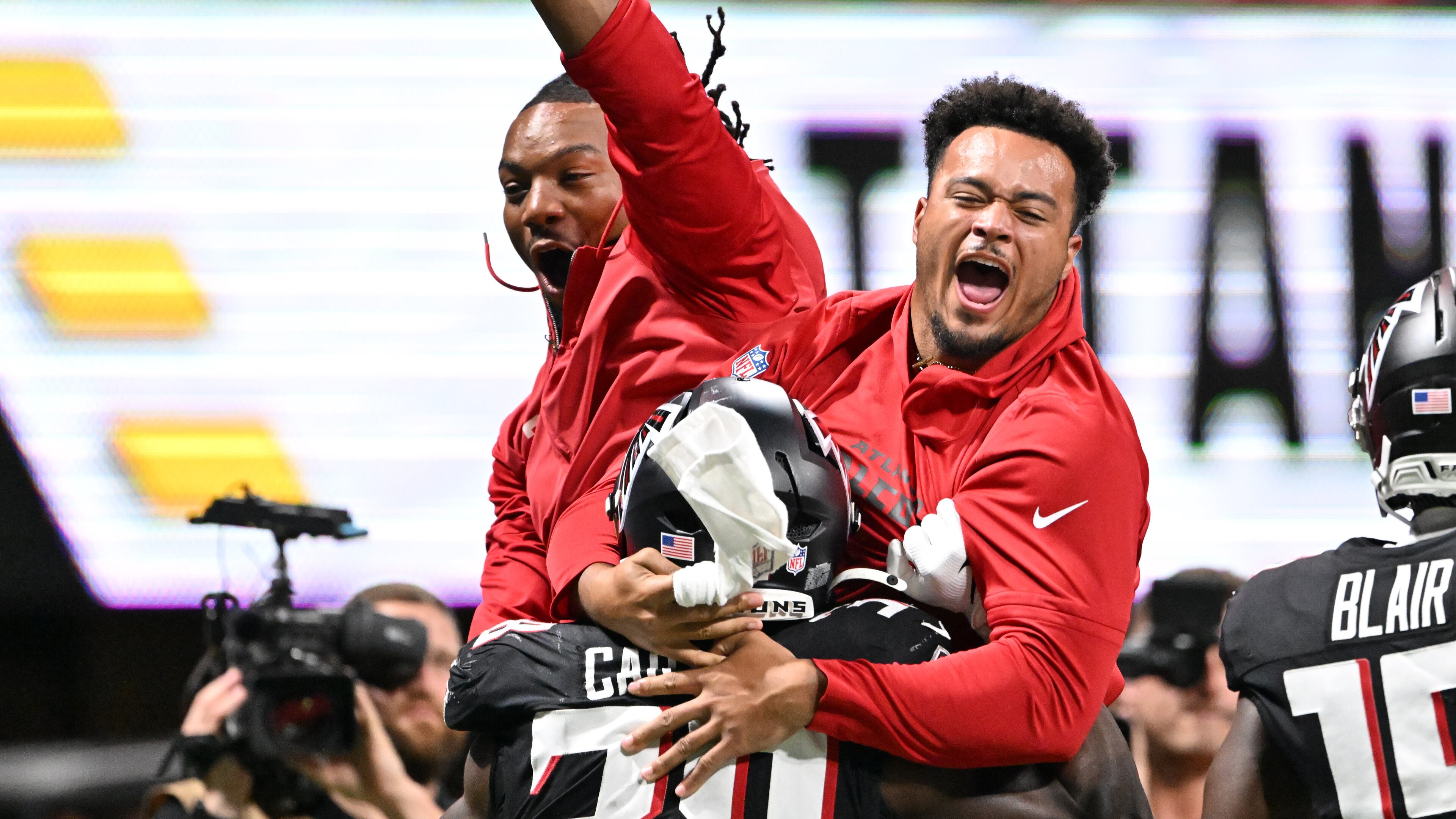 Falcons running back Nathan Carter (38) celebrates a preseason touchdown with Bijan Robinson and Tyler Allgeier.