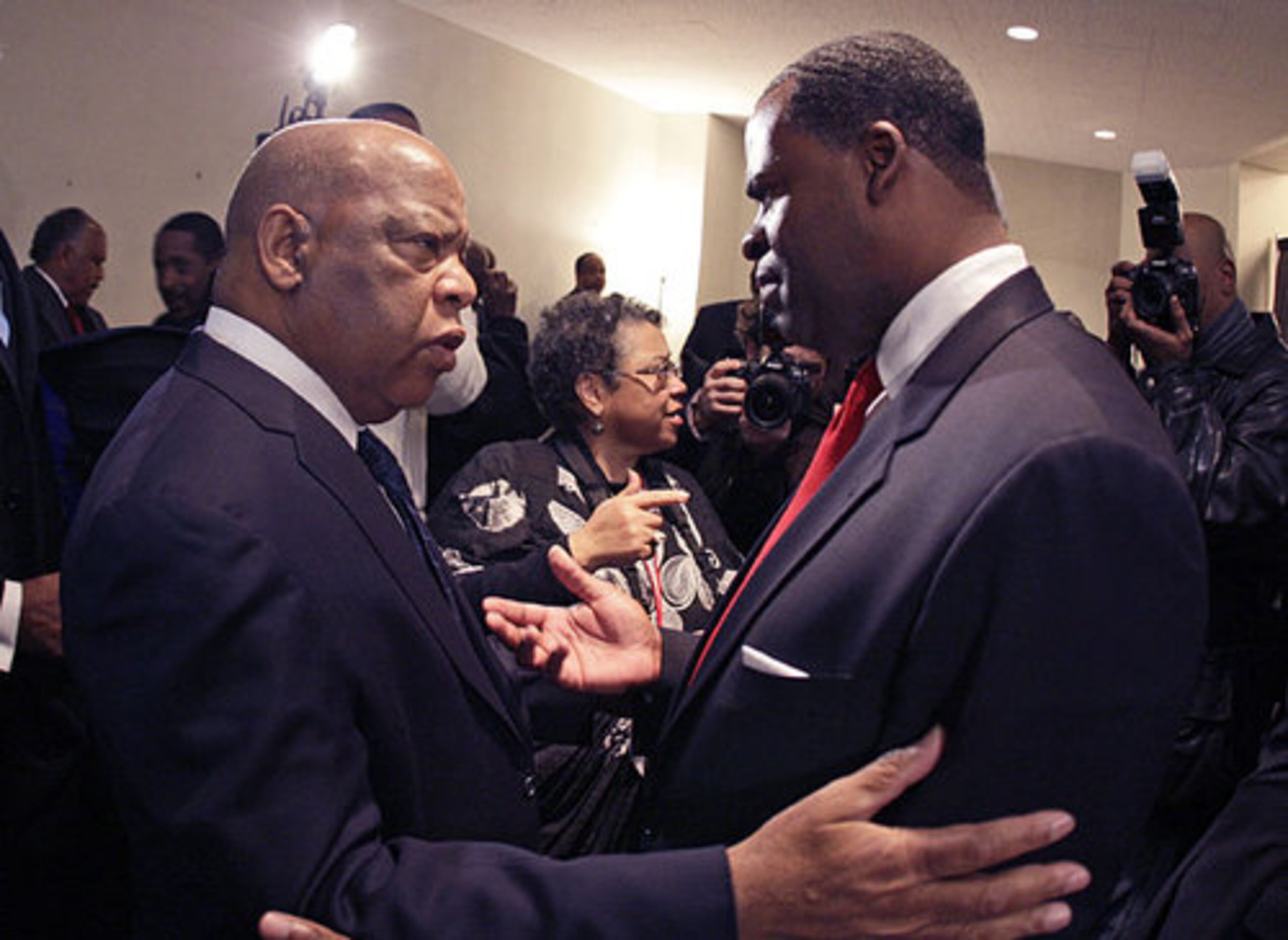 Reed is greeted by Congressman John Lewis backstage after he signed his oath of office papers.