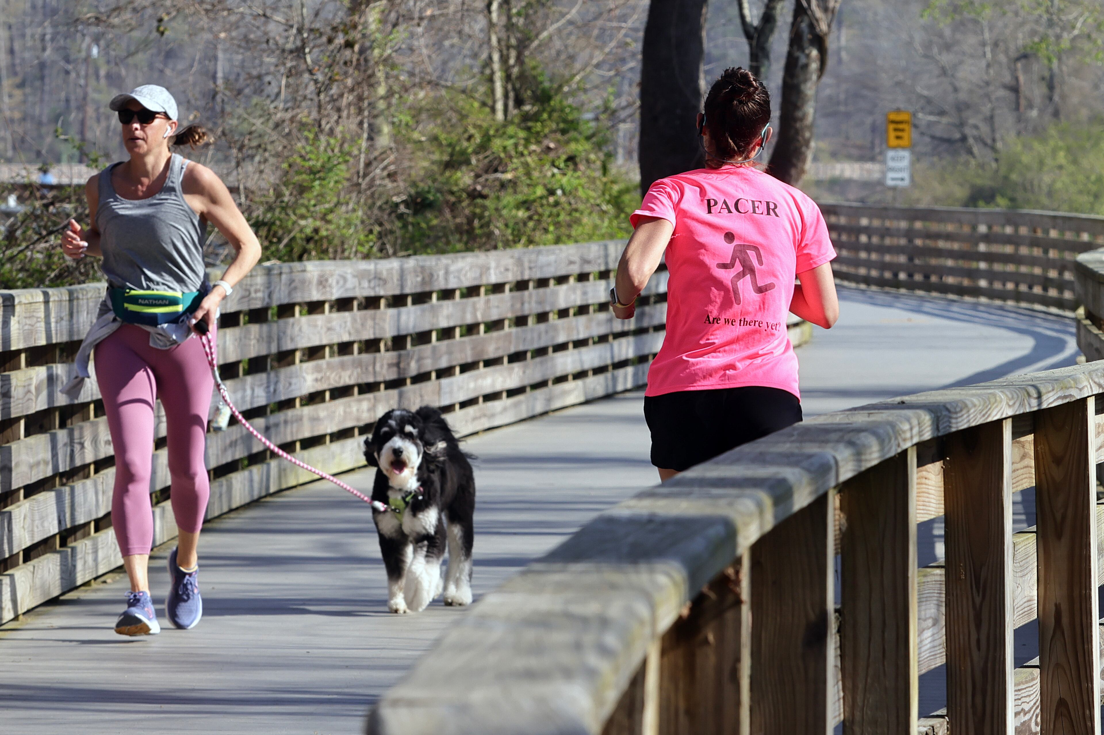People run on the boardwalk at Willeo Park in Roswell on Thursday, March 23, 2023. Temperatures are expected to reach 80 degrees. (Natrice Miller/ natrice.miller@ajc.com)