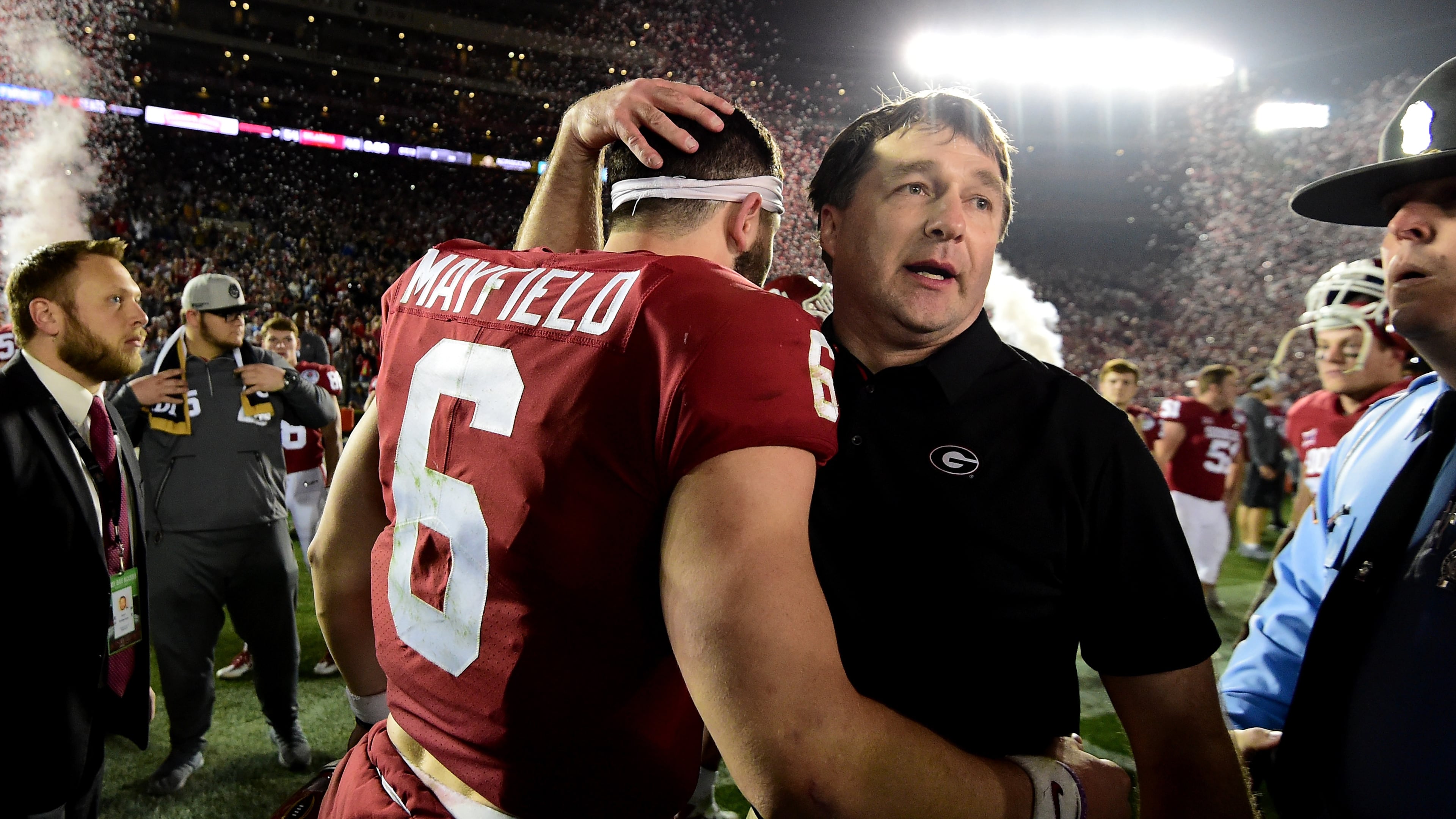Head Coach Kirby Smart of the Georgia Bulldogs hugs quarterback Baker Mayfield of the Oklahoma Sooners after the Bulldogs beat the Oklahoma Sooners 54-48 in double overtime in the 2018 College Football Playoff Semifinal Game at the Rose Bowl Game presented by Northwestern Mutual at the Rose Bowl on Jan. 1, 2018, in Pasadena, California. (Courtesy of Harry How)