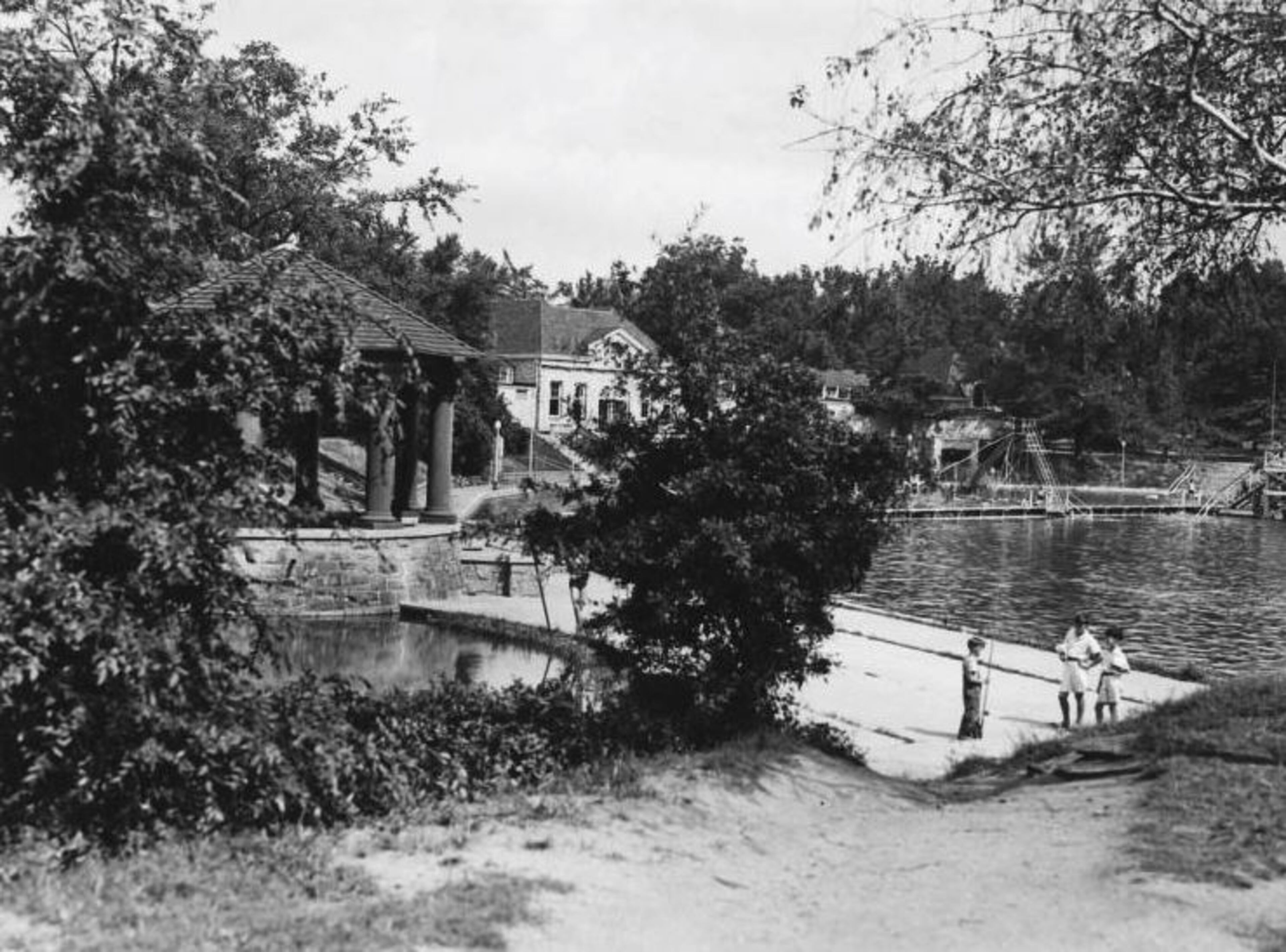 1930s -- Children swim and fish in Clara Meer at Piedmont Park. The stone bathhouse building in the background was constructed in 1926. AJC PHOTO ARCHIVES