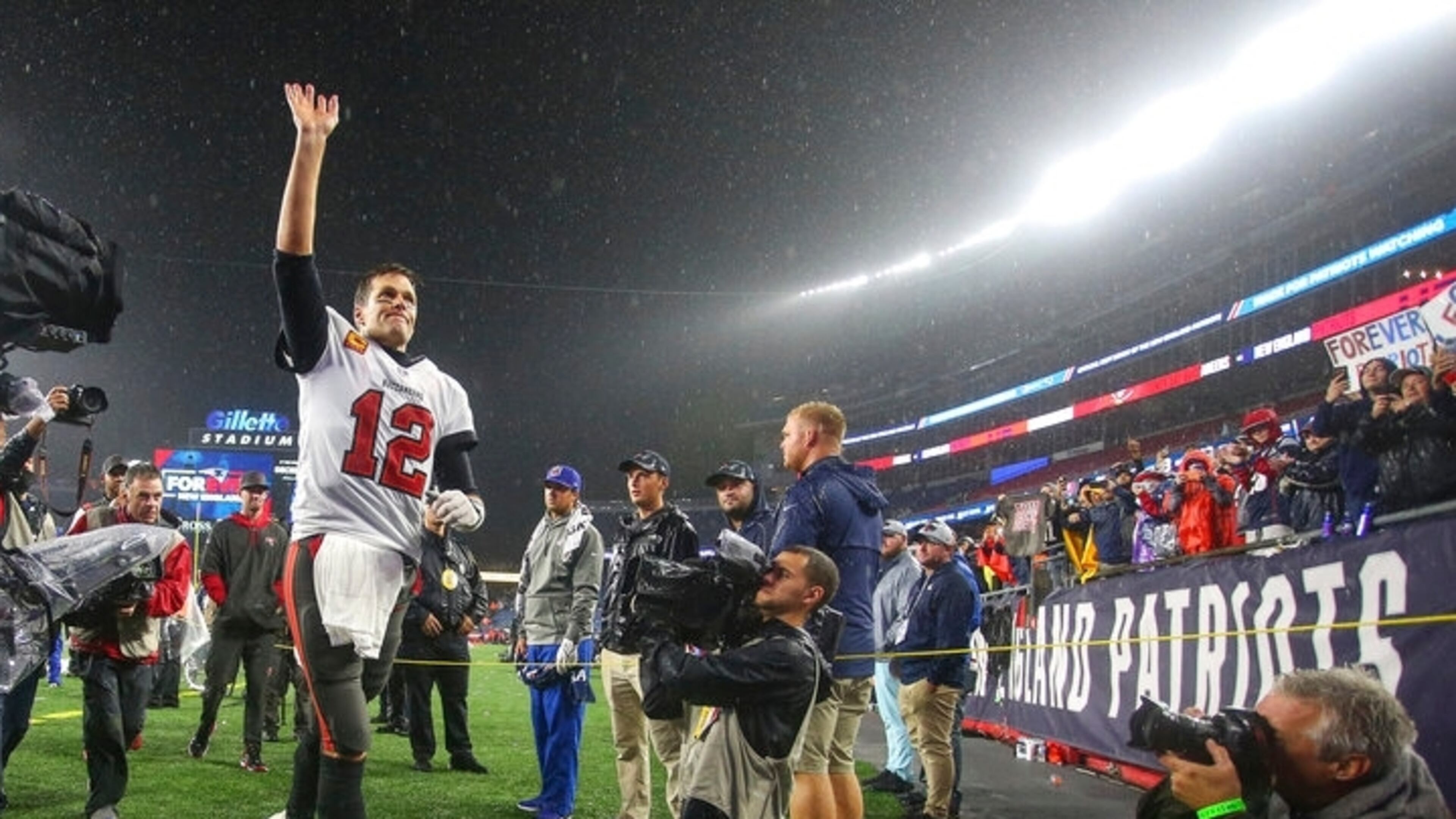 Tampa Bay Buccaneers quarterback Tom Brady (12) waves to the crowd as he runs off the field following an NFL football game against the New England Patriots, Sunday, Oct. 3, 2021, in Foxborough, Mass. (AP Photo/Stew Milne)