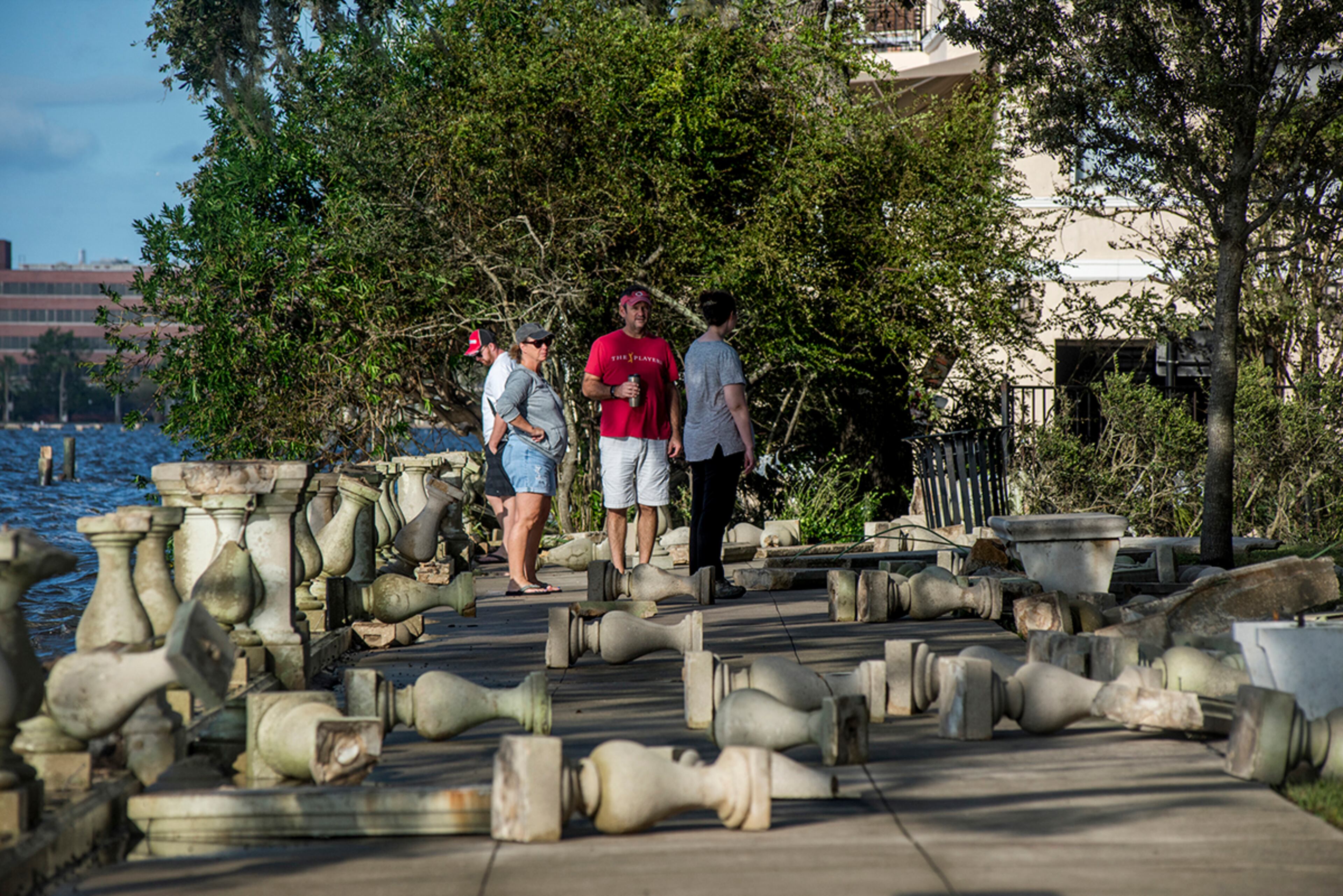 Jacksonville, Fla.: People inspect damages at Memorial Park after floodwaters receded a day after Hurricane Irma, along the St. Johns River in the Riverside neighborhood of Jacksonville, Fla., Sept. 12, 2017. Downgraded to a tropical depression, Irma left Florida in shambles as it moved into Georgia, Alabama and the Carolinas. (Johnny Milano/The New York Times)