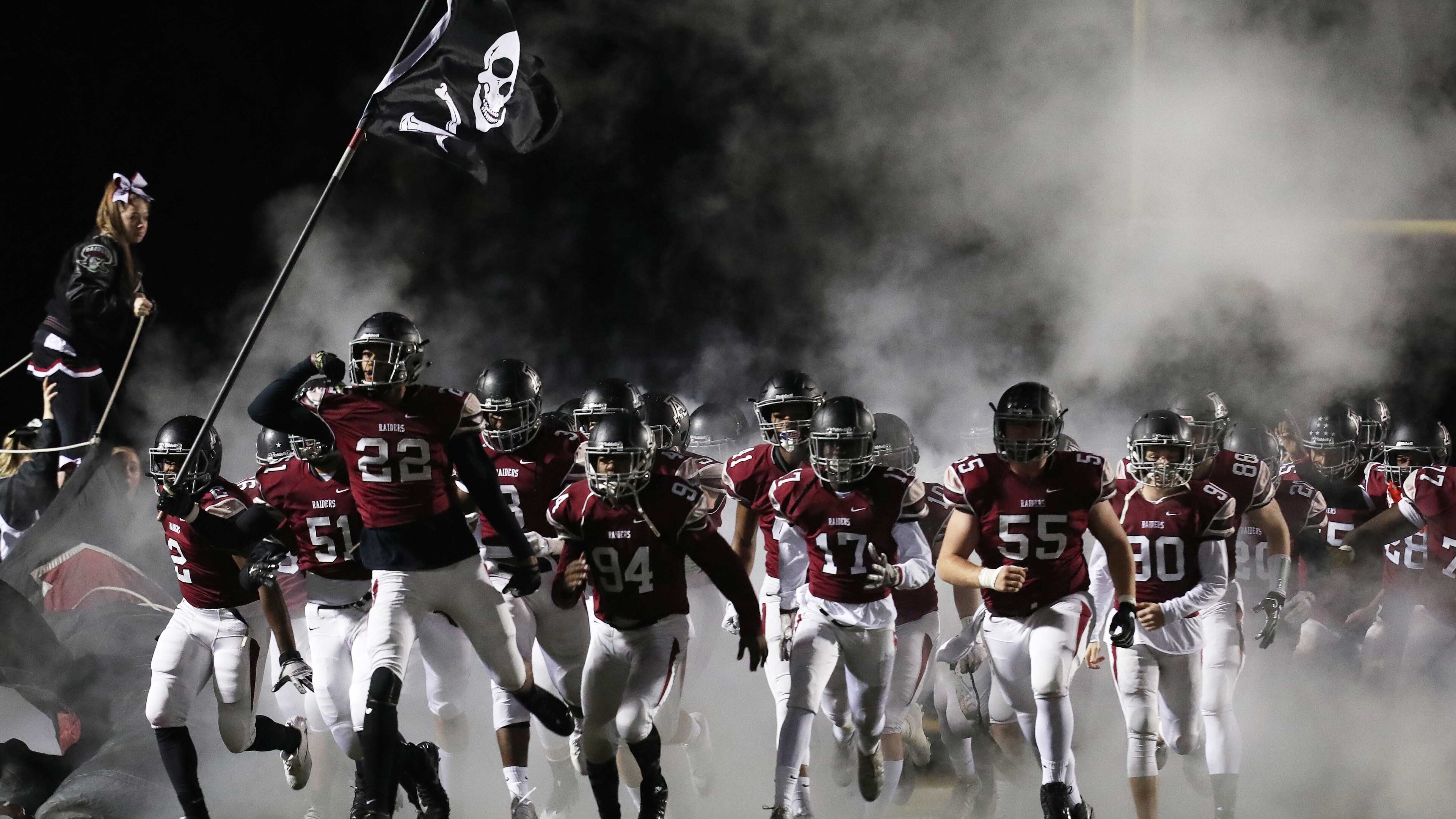 11/24/2017, Alpharetta, GA - The Alpharetta Trojans take the field before the start of the Georgia high school AAAAAA football quarterfinals game against the Coffee Trojans at Raider Stadium, Friday, November 24, 2017, in Alpharetta. The Coffee County Trojans (8-3) took on the Alpharetta Raiders (11-1) during the Georgia high school AAAAAA football quarterfinals. ALYSSA POINTER/ALYSSA.POINTER@AJC.COM