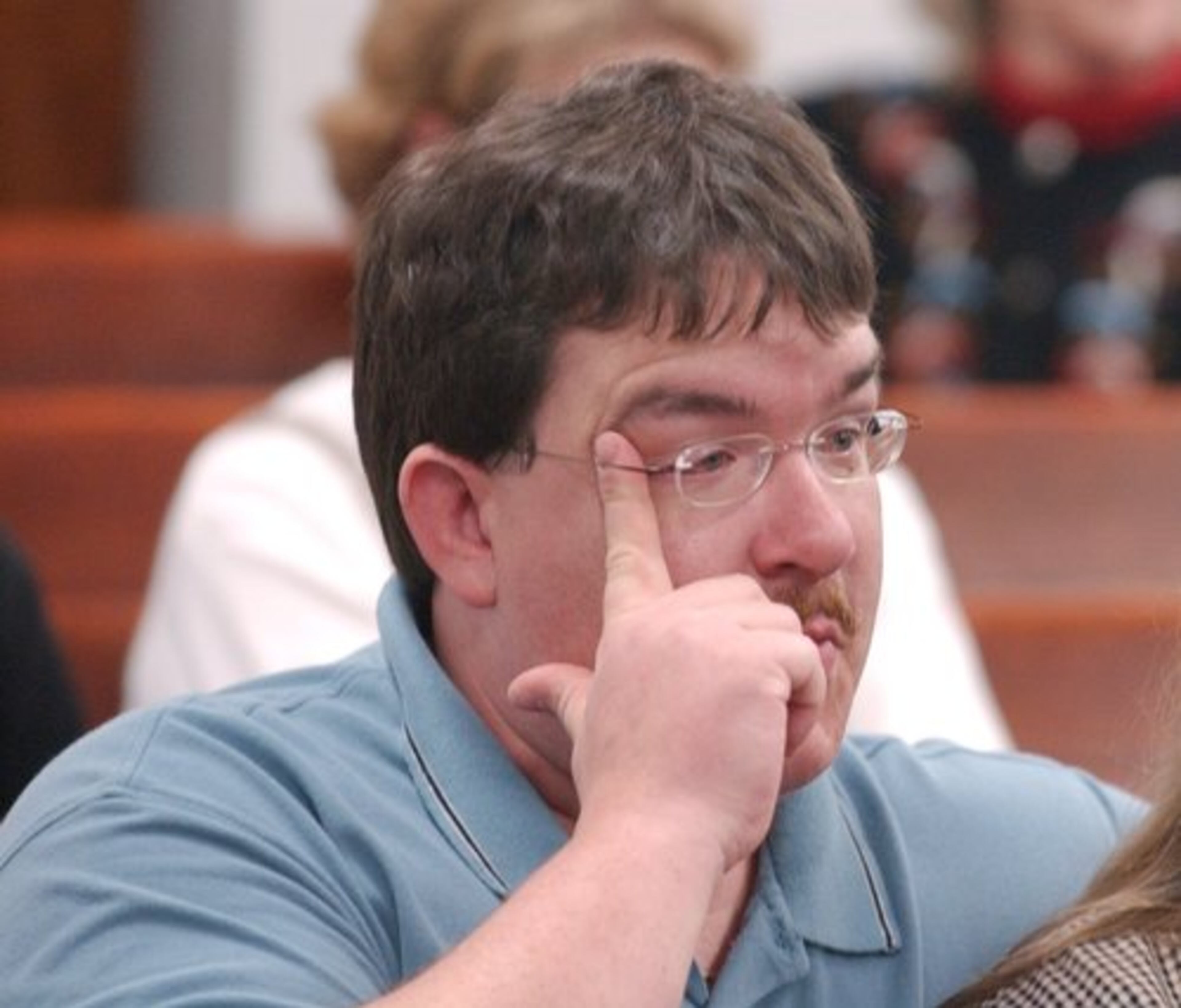 In November 2002, James Turner, brother of Glenn Turner, wipes a tear away as the indictment against Lynn Turner was read in court.