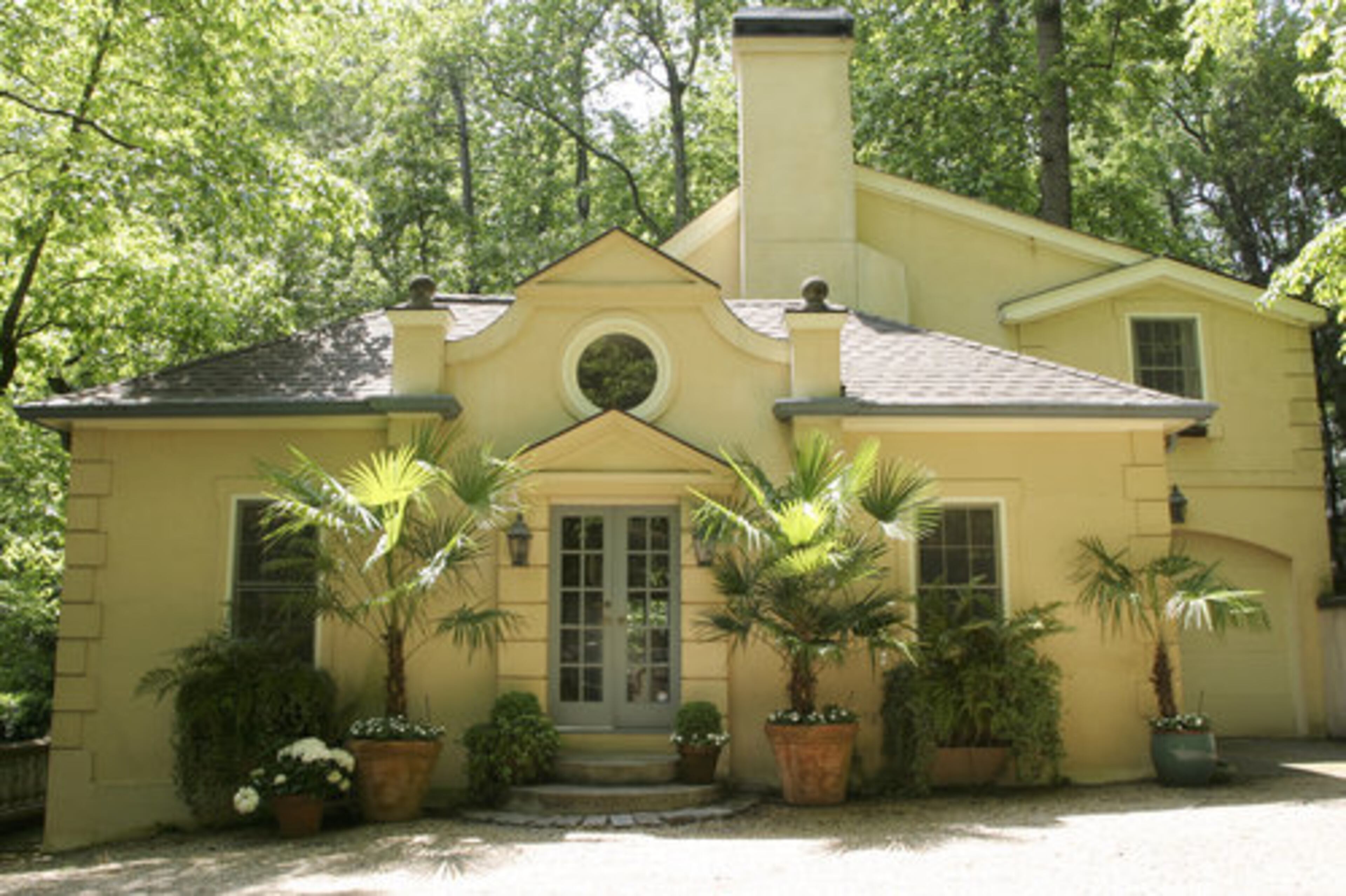 "We totally redesigned the front of the house," shares Mary. "We added window boxes, brought all the pots in and did all the landscaping. We have ferns, windmill palms, impatiens, boxwoods and the vines growing in the courtyard are Virginia Creeper and trumpet vine."