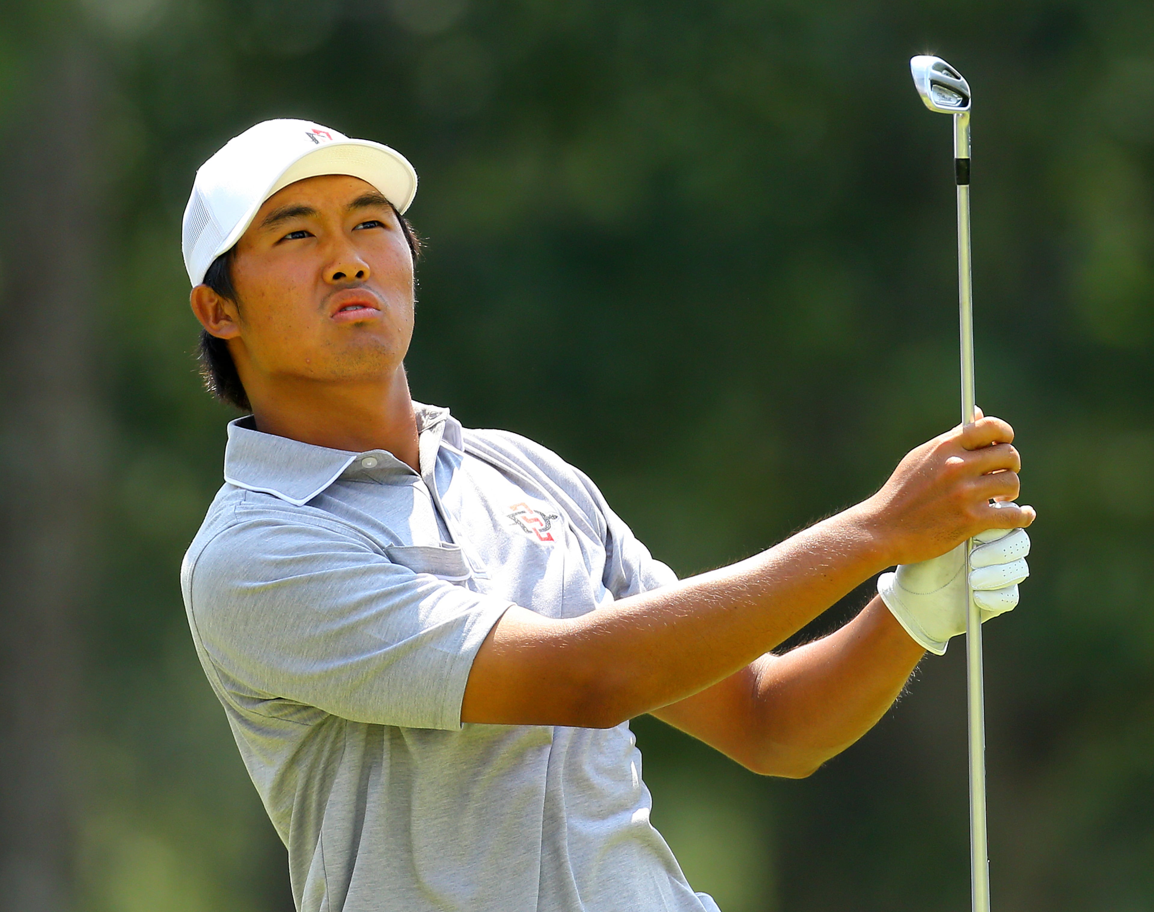 Gunn Yang, San Diego, California, tees off on the par-3 hole no.17 during the morning session of the 36-hole championship match of the 2014 U.S. Amateur Championship at Atlanta Athletic Club on Sunday, August 17, 2014, in Johns Creek.