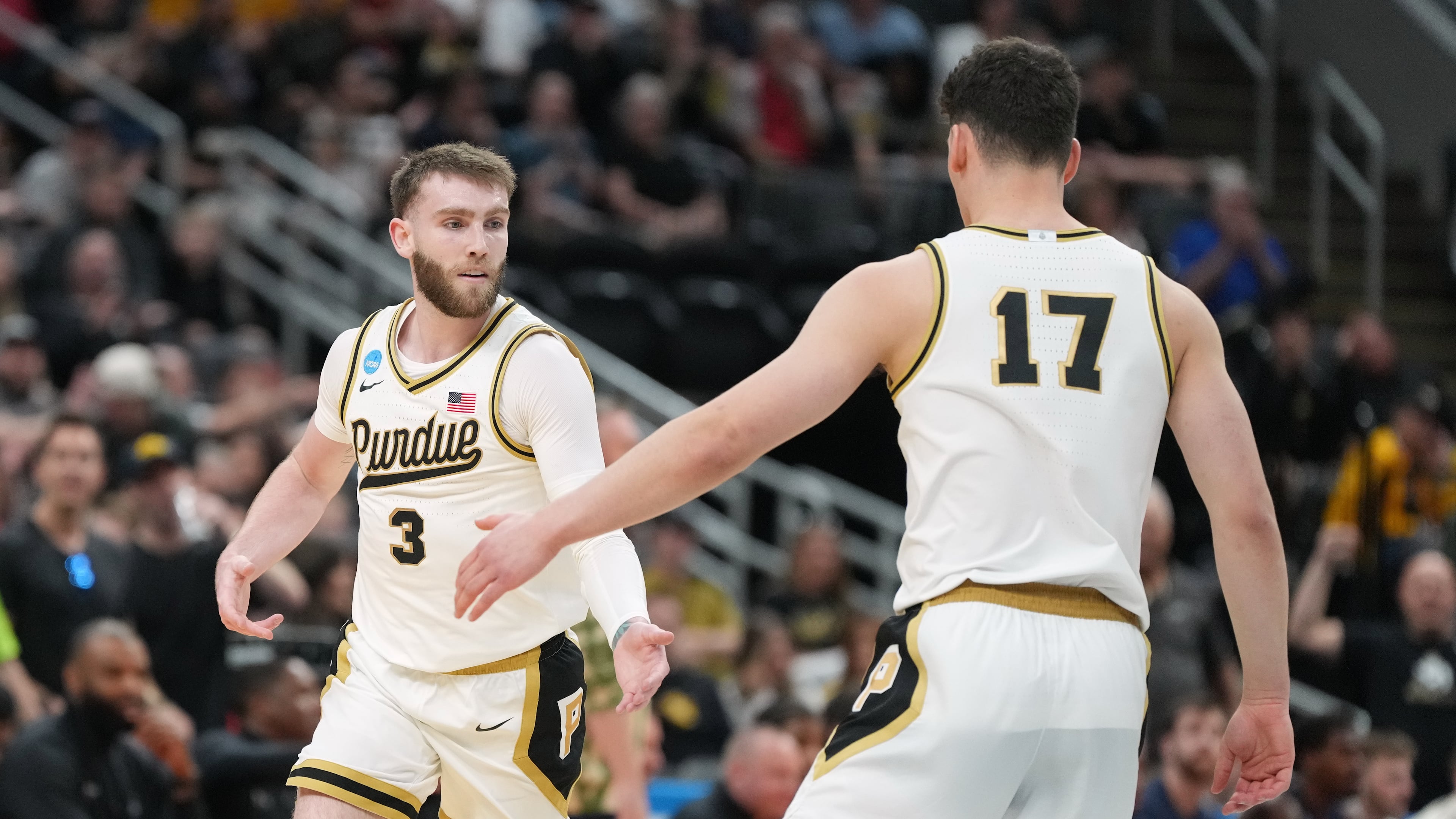 Purdue's Braden Smith (3) is congratulated by teammate Omer Mayer (17) after making a 3-point basket during the first half in the first round of the NCAA college basketball tournament against Queens University, Friday, March 20, 2026, in St. Louis. (AP Photo/Jeff Roberson)