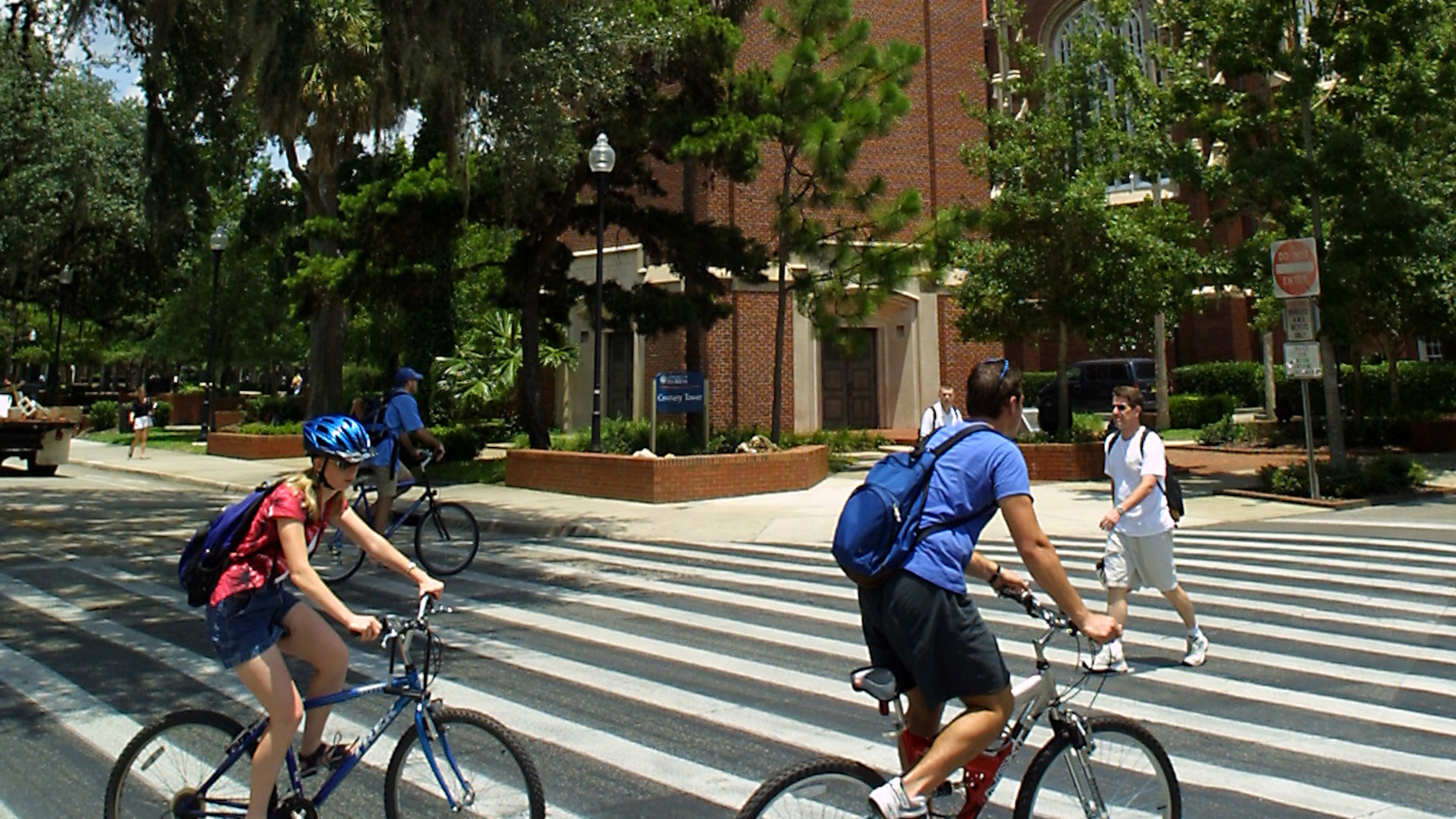 FILE - University of Florida students make their way through a crosswalk near the campus landmark Century Tower in Gainesville Fla. (AP Photo/Rob C. Witzel, file)