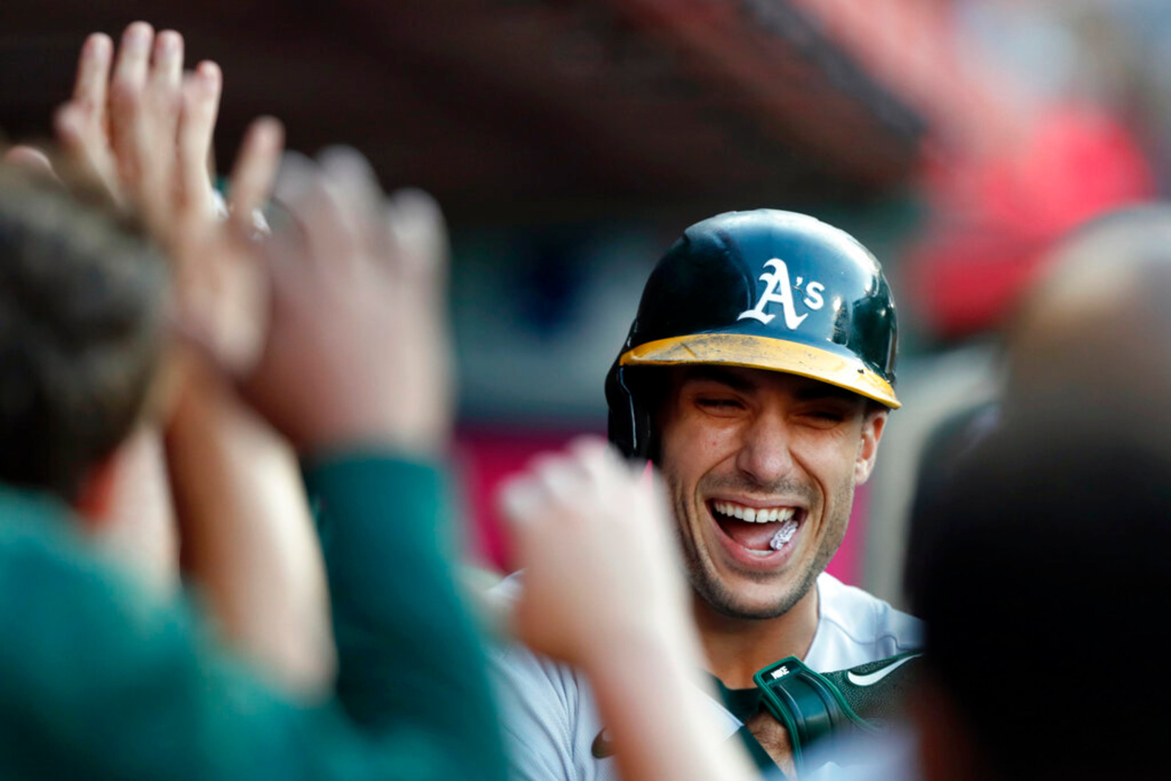 Oakland Athletics' Matt Olson gets celebrates with teammates after hitting a solo home run against the Los Angeles Angels during the first inning of a baseball game in Anaheim, Calif., Saturday, Sept. 18, 2021. (AP Photo/Alex Gallardo)