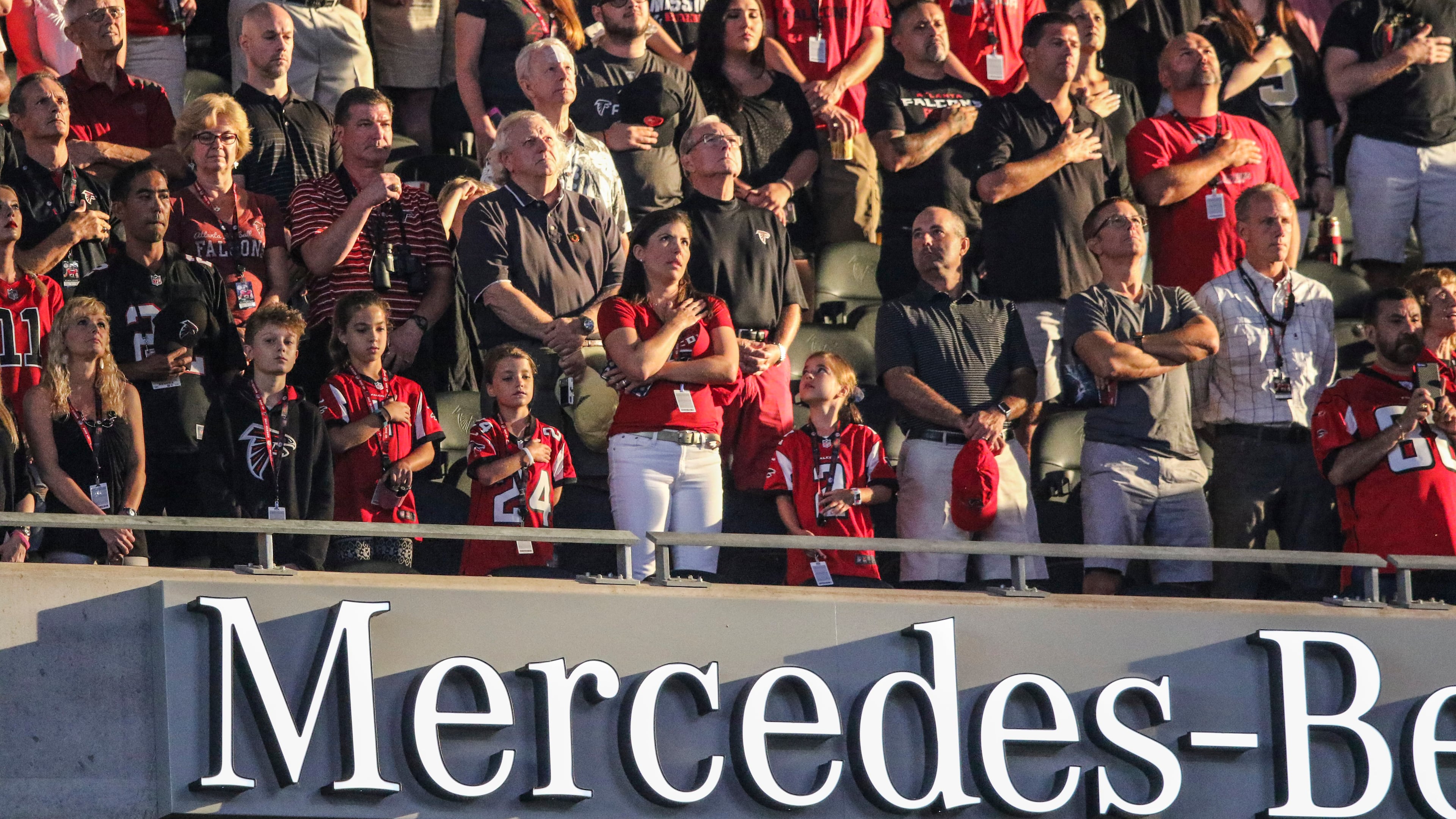 Falcons fans stand at attention during the national anthem Saturday, Aug. 26, 2017, at the opening game of Mercedes Benz Stadium against the Arizona Cardinals.