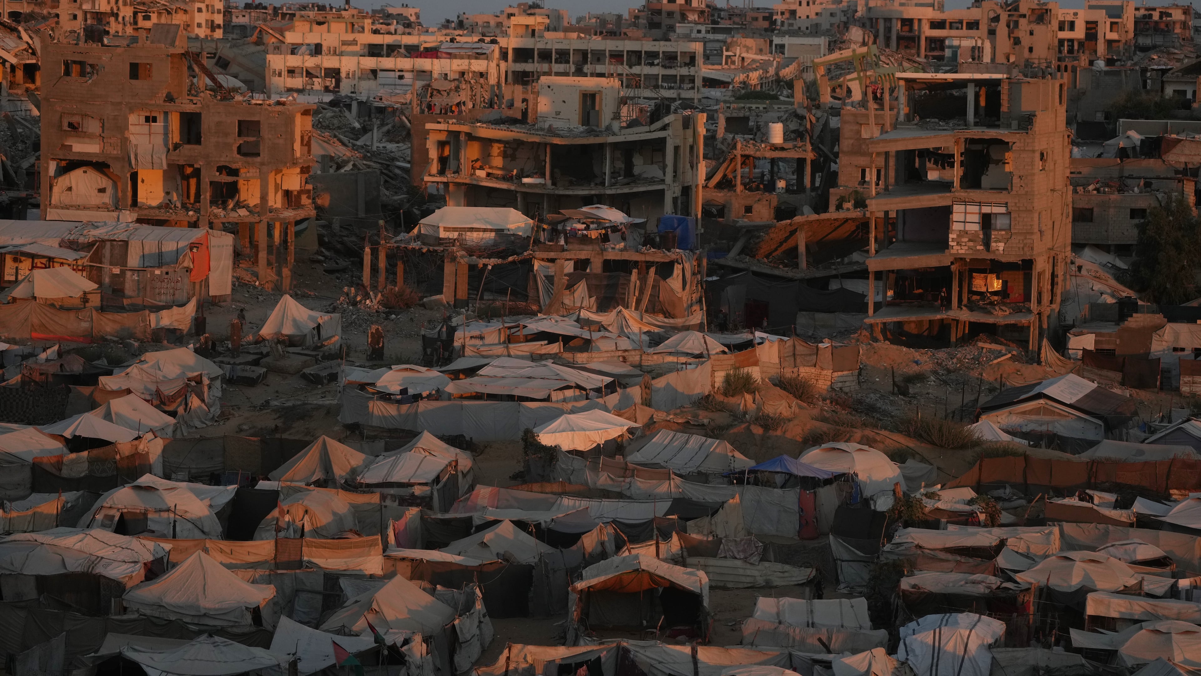 Tents sheltering displaced Palestinians are seen amid war-damaged buildings in Gaza City, Saturday, Sept. 26, 2026. (AP Photo/Jehad Alshrafi)