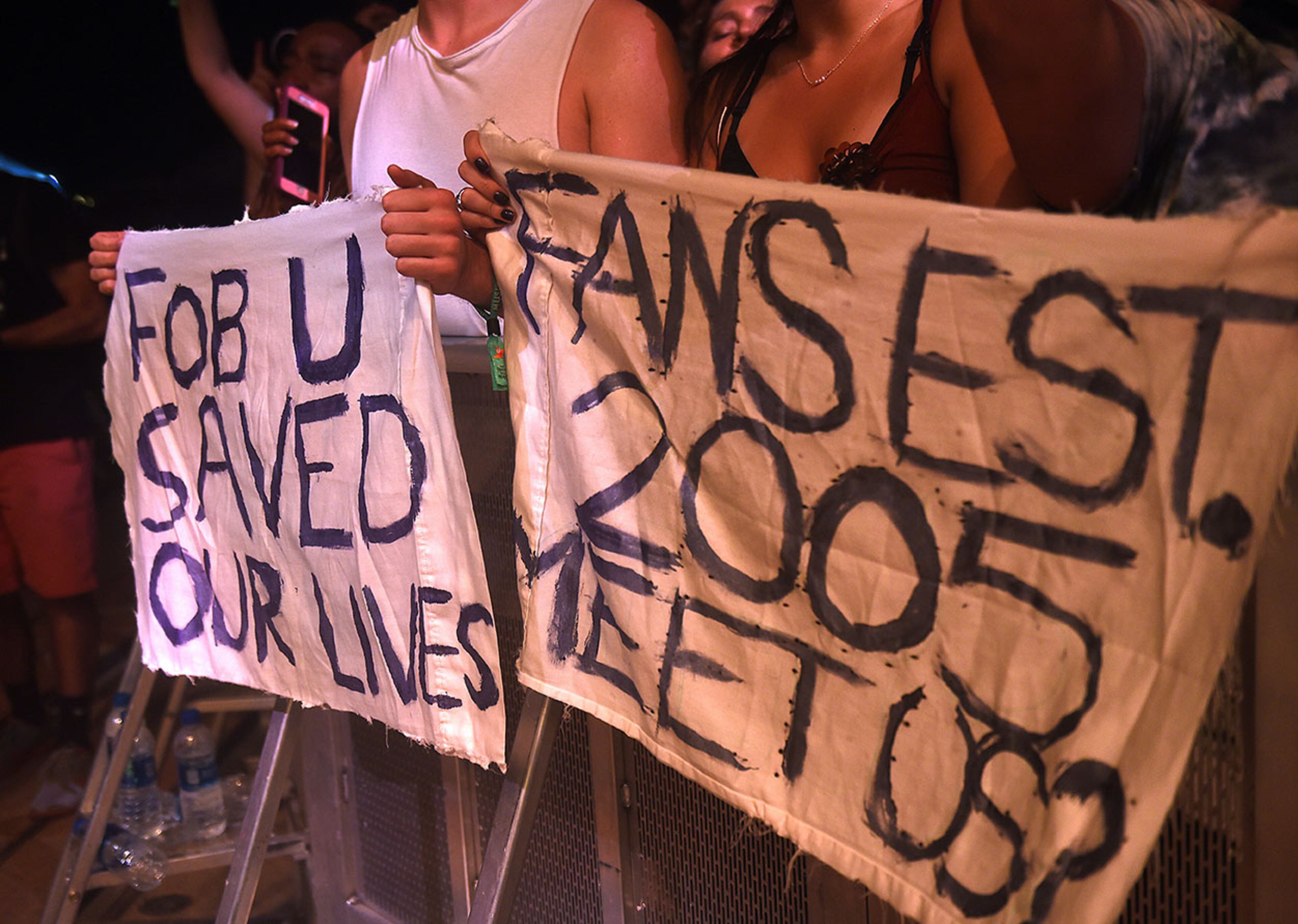 Atlanta A concertgoers hold a sign at the front of the stage for the band Fall Out Boy performs on the Roxy Stage on day one of Music Midtown in Piedmont Park. The two-day festival includes Imagine Dragons, Kendrick Lamar, and Post Malone. RYON HORNE/RHORNE@AJC.COM