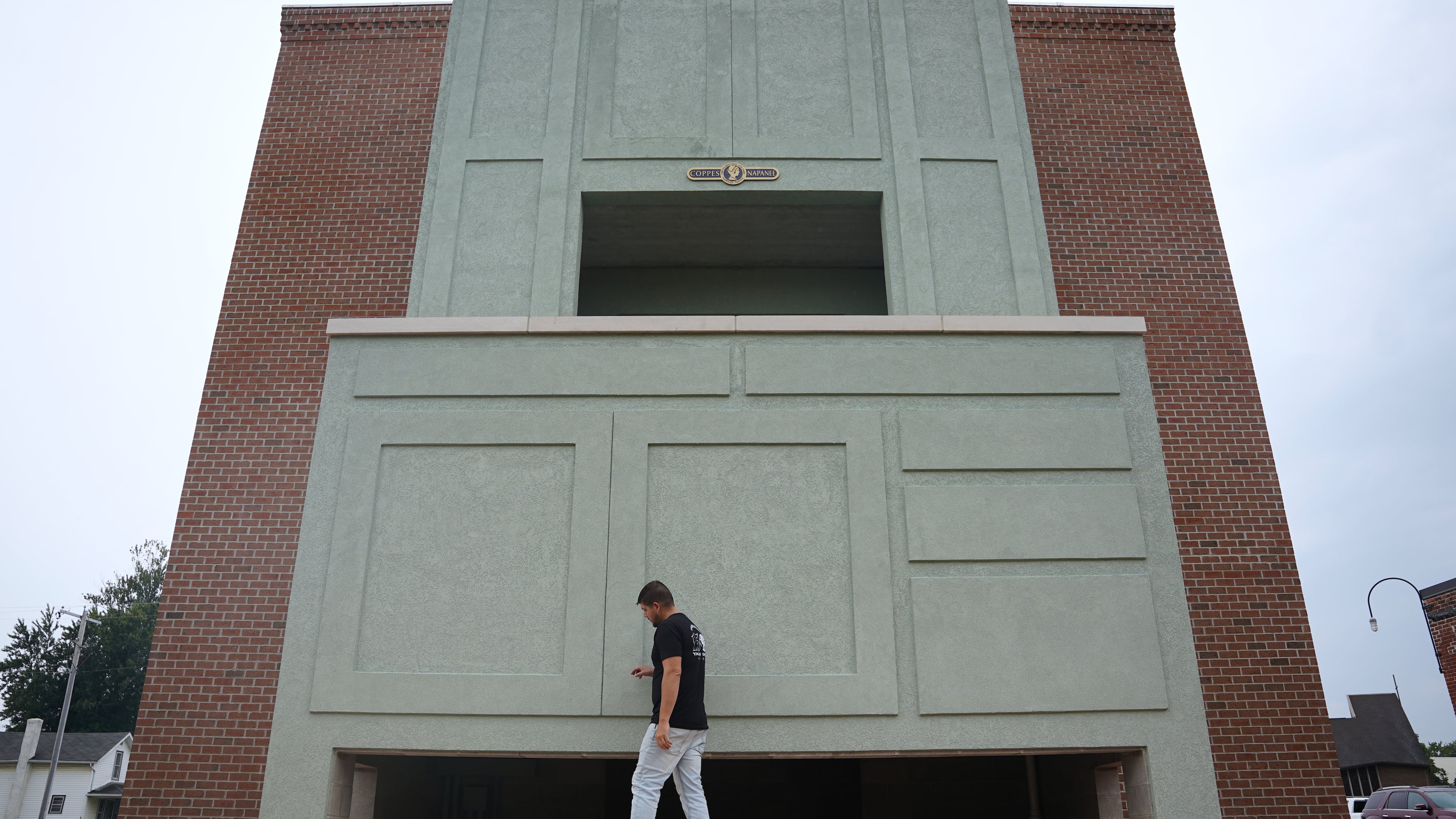 Wesley Mast, owner and president of Coppes Napanee, walks past a giant replica of a Hoosier cabinet in Nappanee, Ind., Thursday, Aug. 6, 2026. (AP Photo/Obed Lamy)