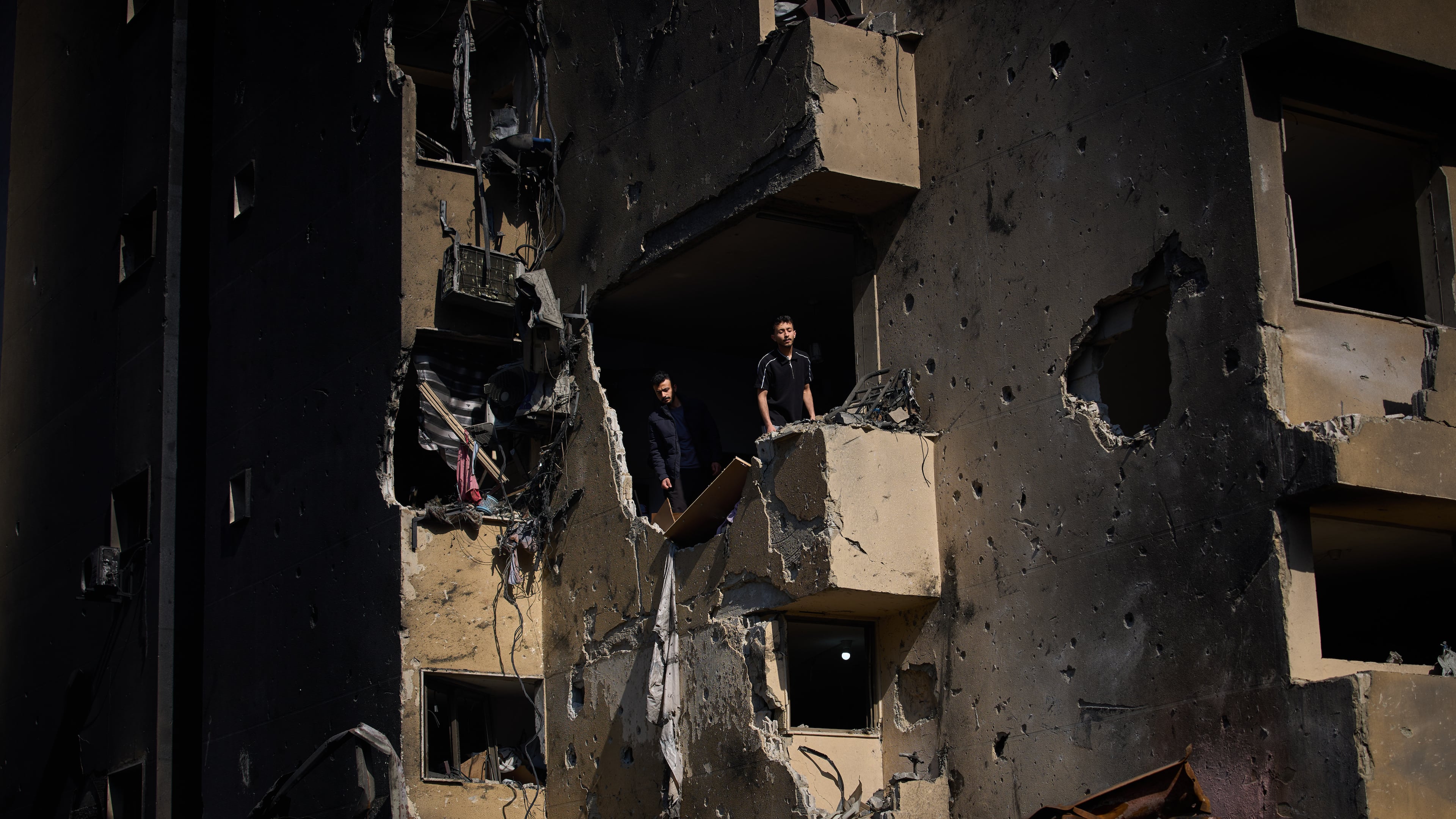 Men inspect the damage to their home destroyed in an Israeli airstrike a day earlier in Beirut, Lebanon, Thursday, April 9, 2026. (AP Photo/Emilio Morenatti)