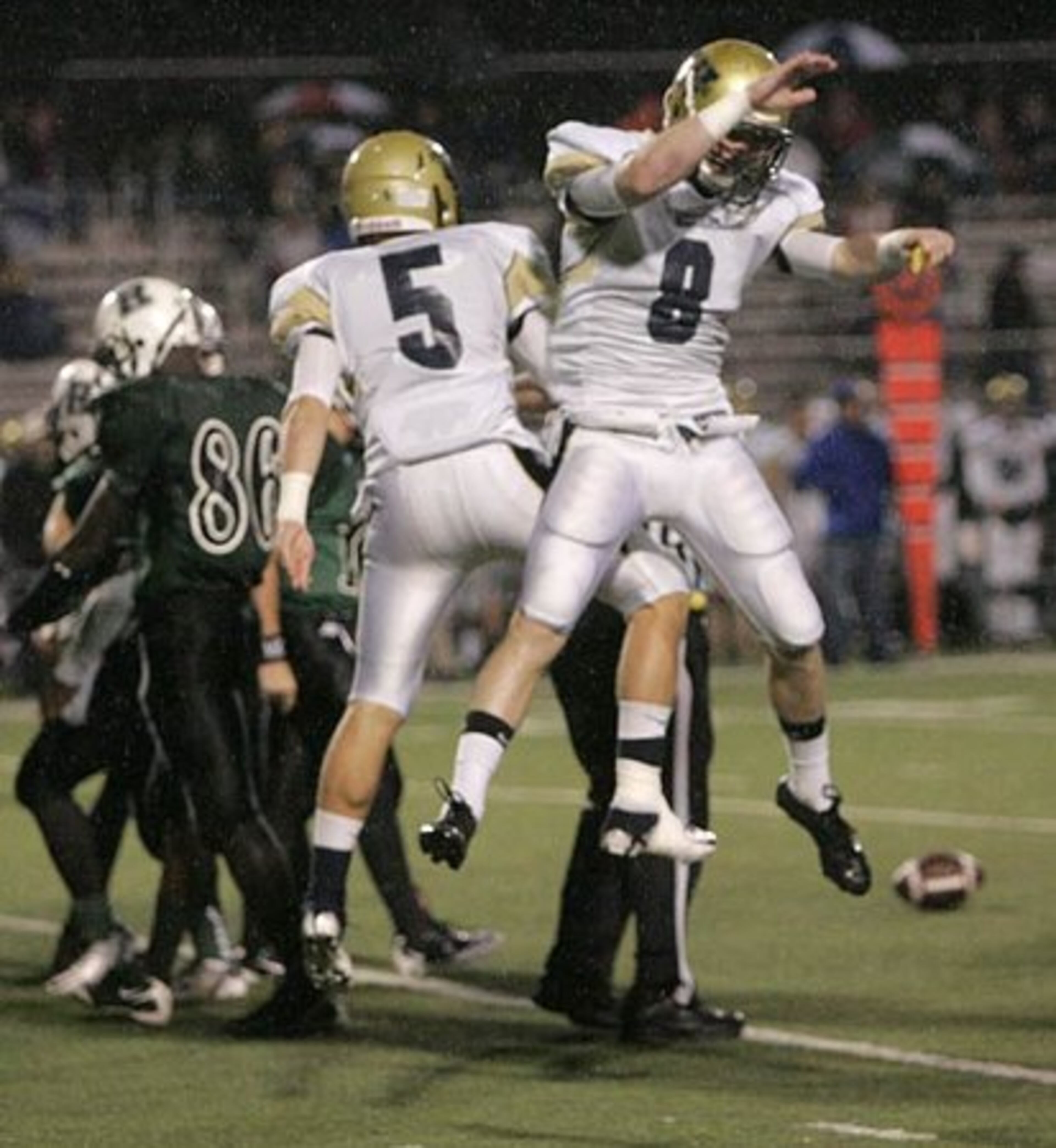 West Forsyth linebacker Wes Rood (5) and Trevor Gutherrie (8) celebrate a Roswell turnover.