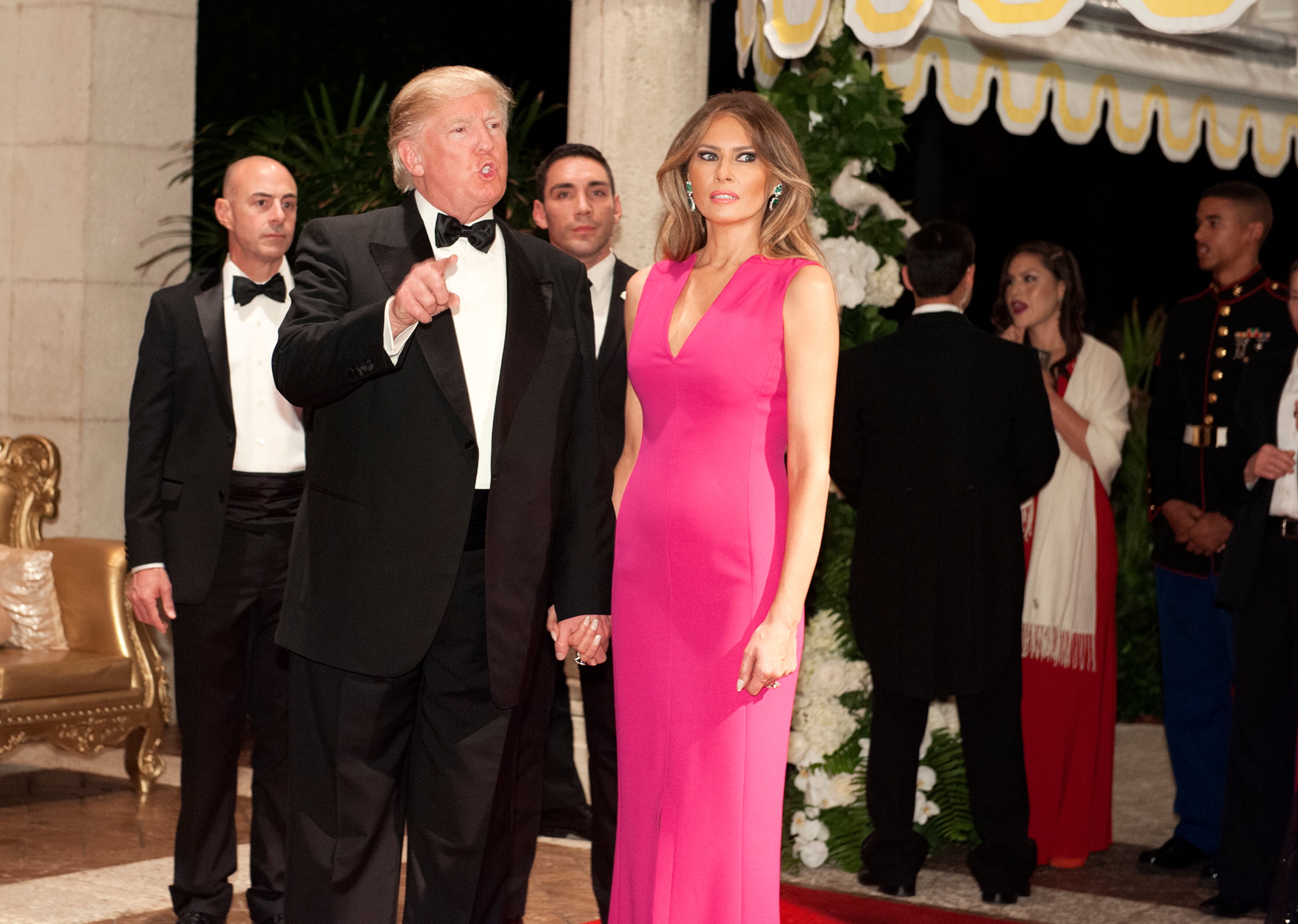 Donald Trump and Melania Trump arrive at the Diamond Centennial Red Cross Ball at Mar-a-Lago Club Saturday.