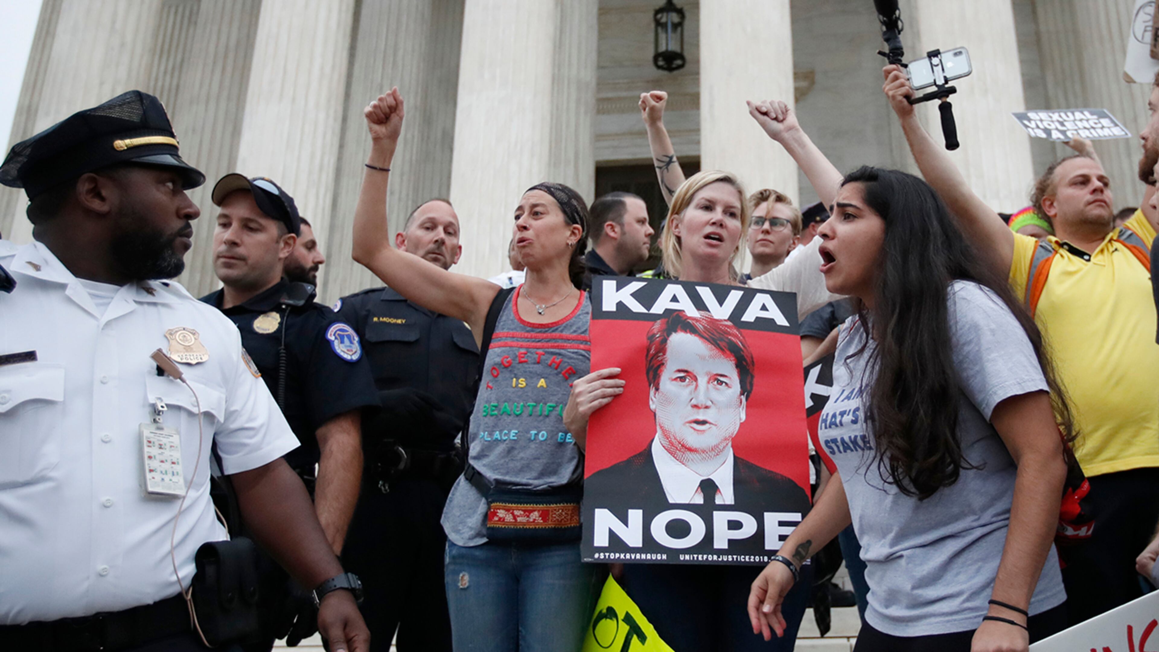 Police move activists as they protest on the steps of the Supreme Court after the confirmation vote of Supreme Court nominee Brett Kavanaugh, on Capitol Hill, Saturday, Oct. 6, 2018 in Washington. (AP Photo/Alex Brandon)