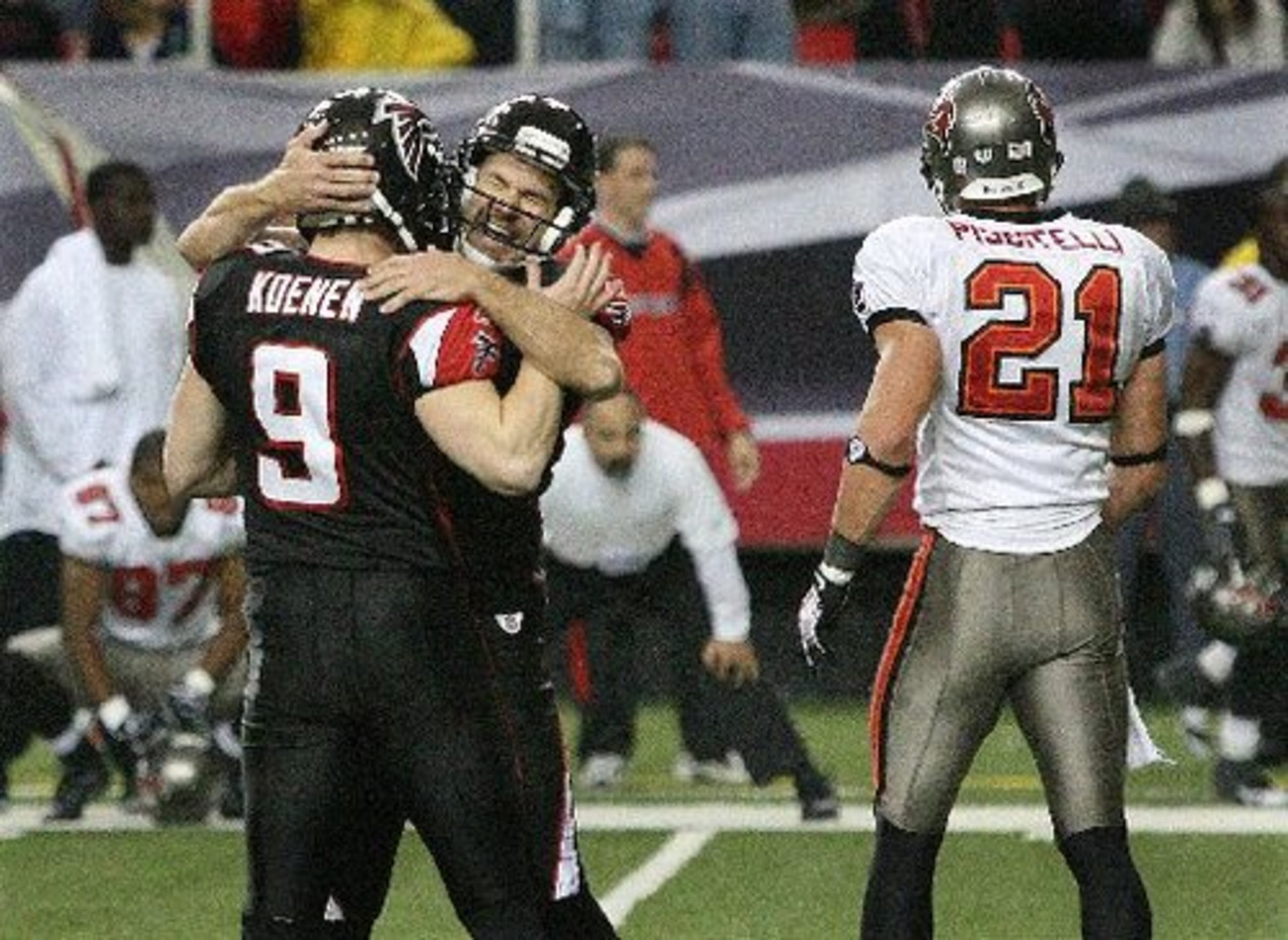 Elam and holder Michael Koenen celebrate the winning kick, which Tampa Bay's Sabby Piscitelli (21) had hoped to block.