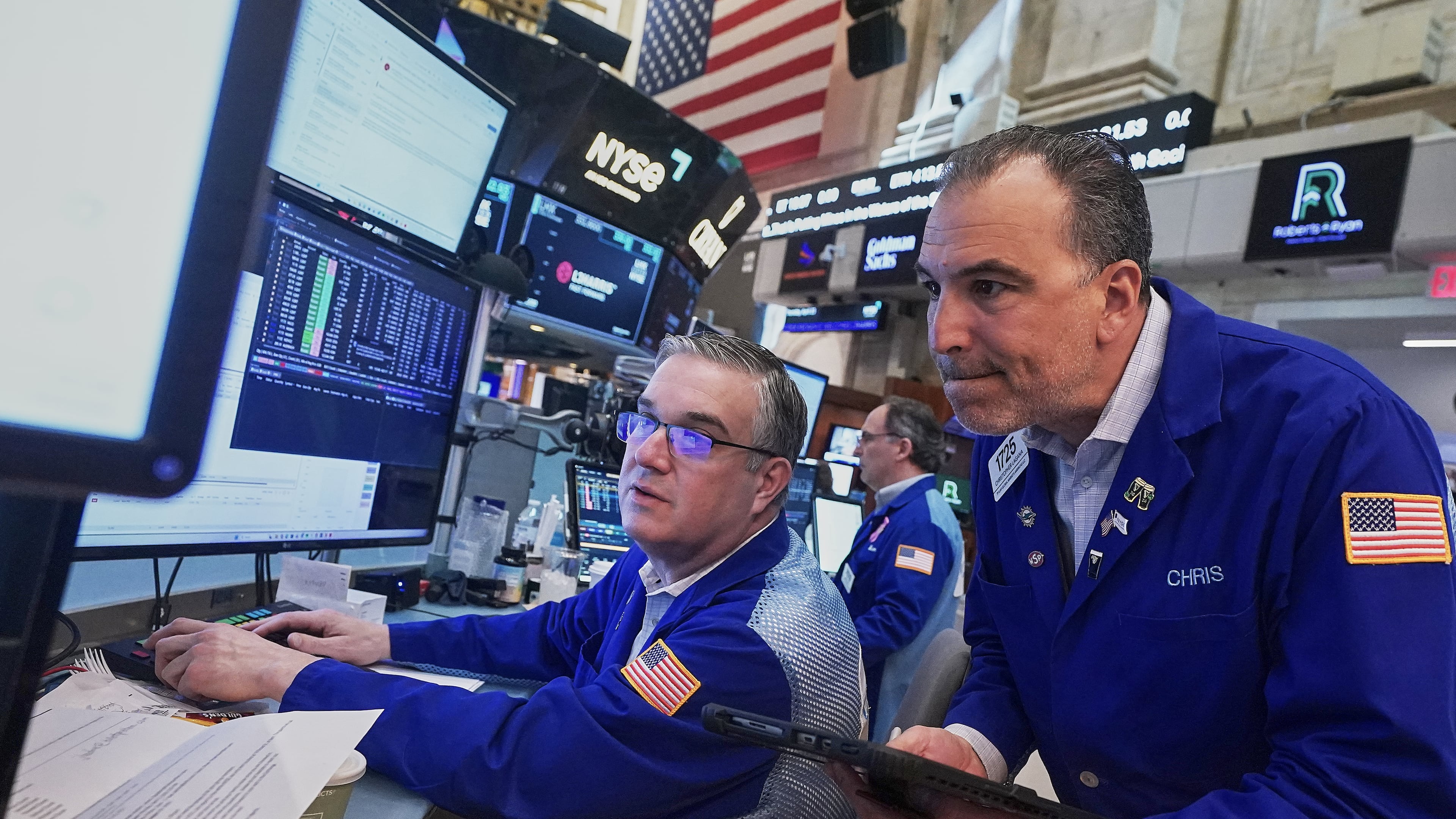 Traders Jim Bodner, left, and Chris Lagana work on the floor of the New York Stock Exchange, Thursday, April 23, 2026. (AP Photo/Richard Drew)