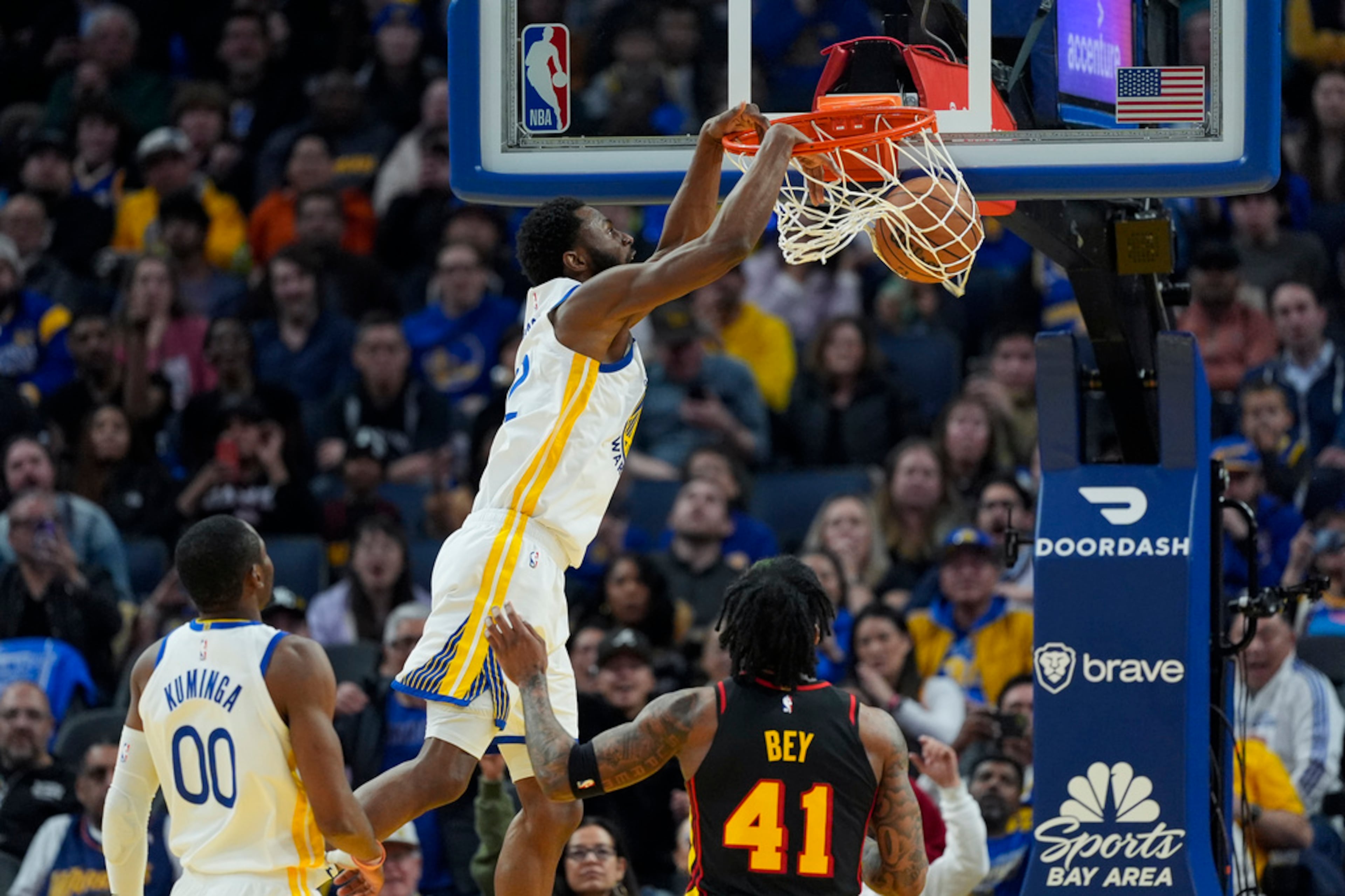 Golden State Warriors forward Andrew Wiggins, second from left, dunks against the Atlanta Hawks during the first half of an NBA basketball game, Wednesday, Jan. 24, 2024, in San Francisco. The Warriors won 134-112. (AP Photo/Godofredo A. Vásquez)