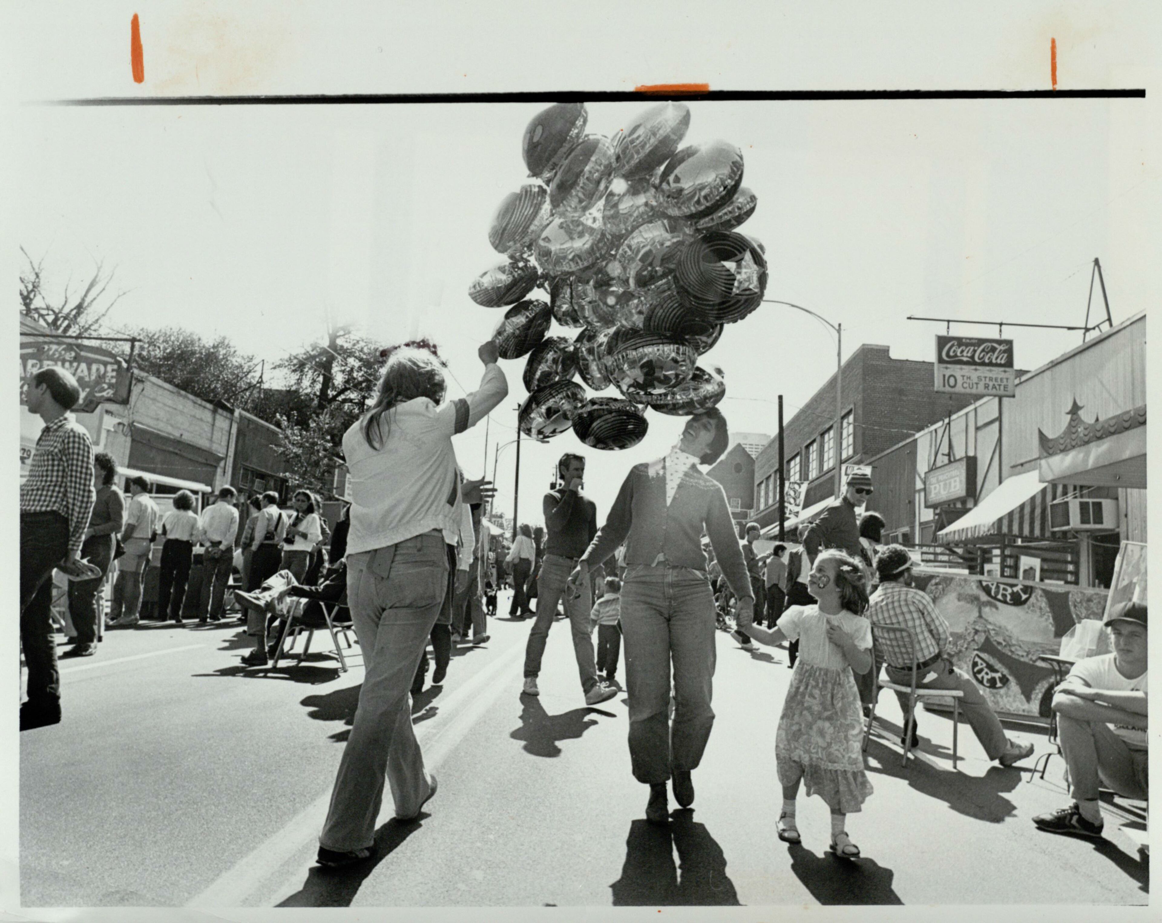 Ann Cramer and her daughter, Megan, walk the streets during the Much Ado About Midtown festival, October 17, 1982. Nick Arroyo/AJC