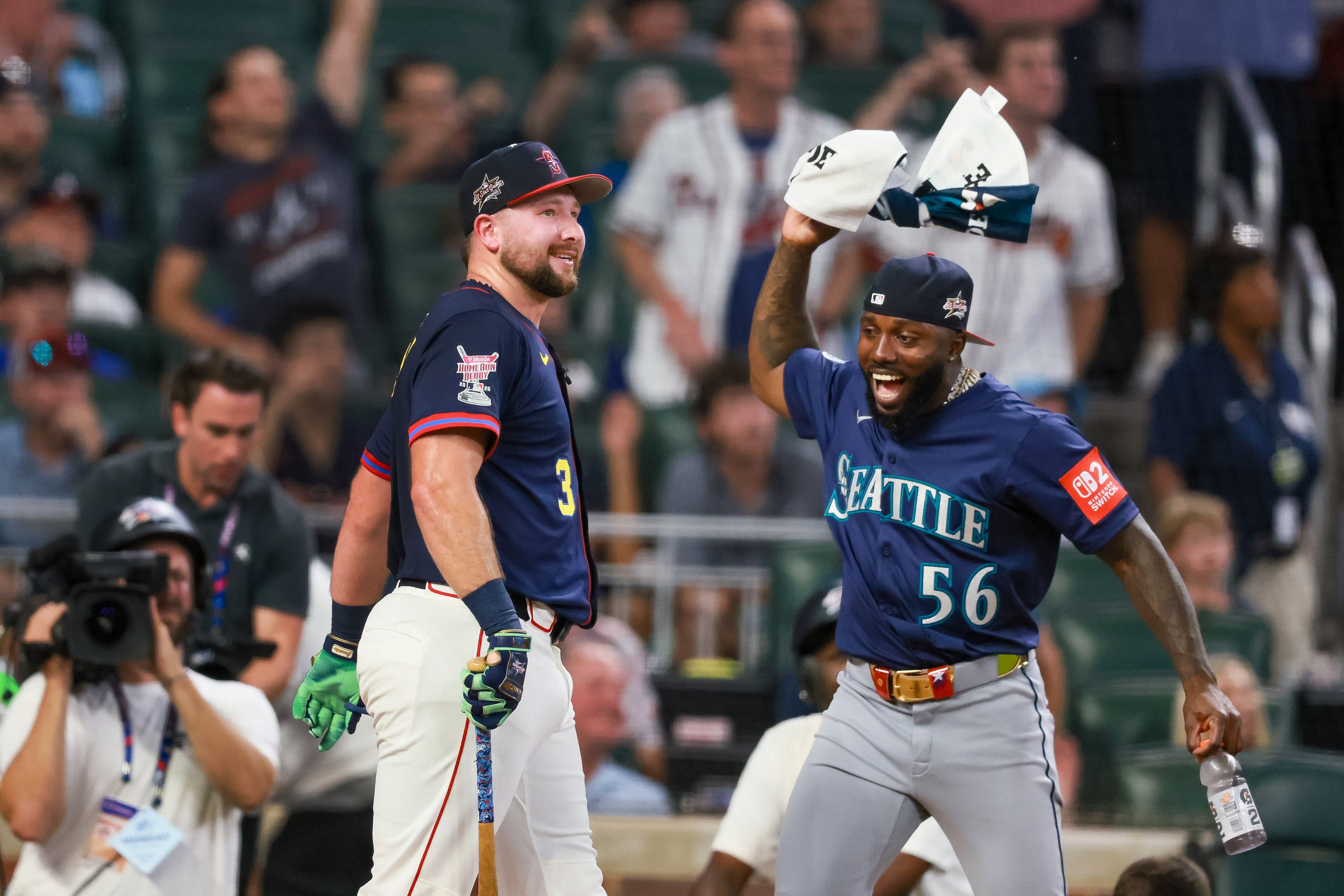 Mariners catcher Cal Raleigh (left) is celebrated by teammate and outfielder Randy Arozarena as Raleigh wins the MLB Home Run Derby on Monday, July 14, 2025, at Truist Park in Atlanta. Raleigh took home a million-dollar prize for his win. (Jason Getz/AJC)