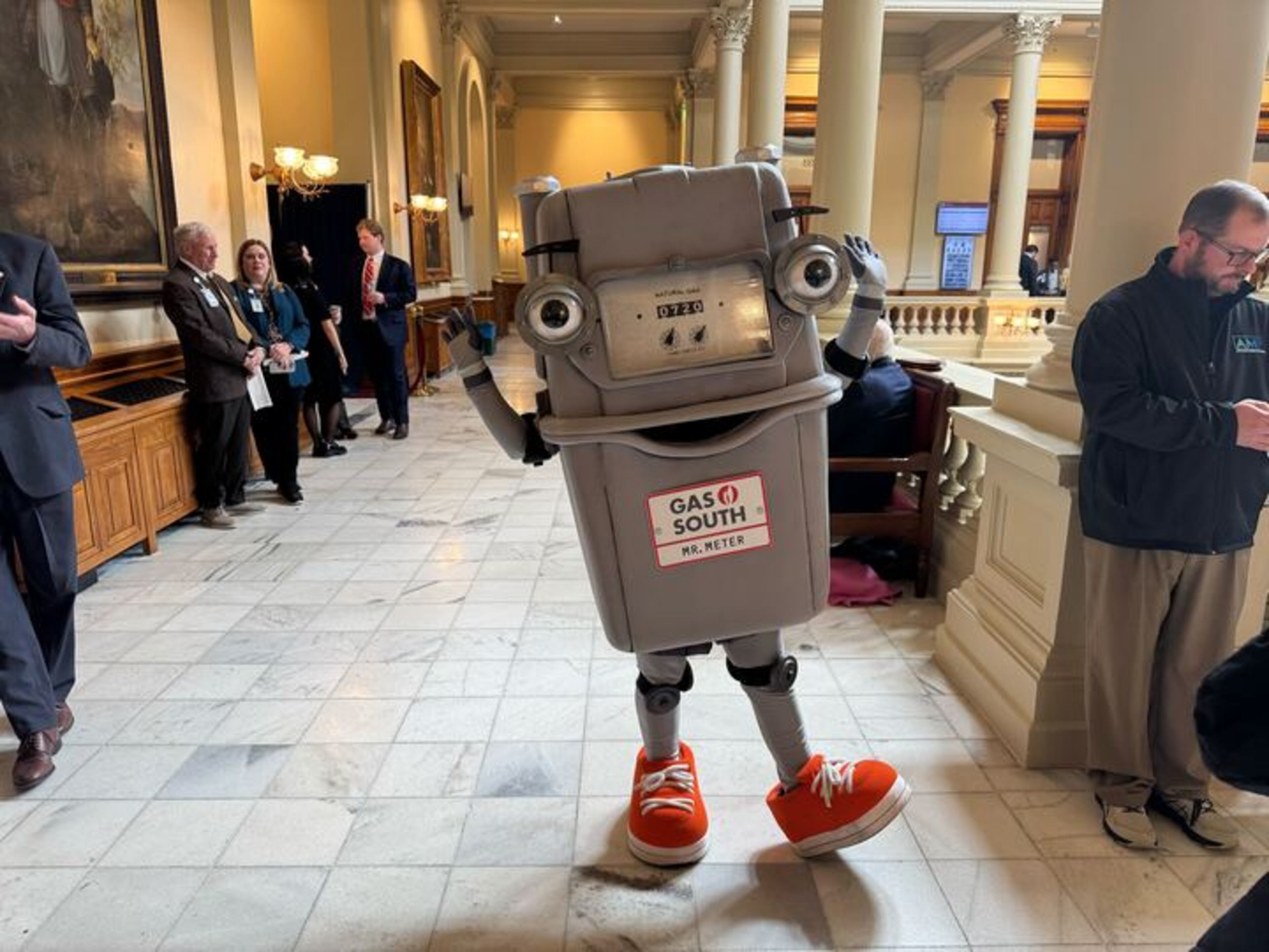 Mr. Meter, a mascot for Gas South, roamed the halls of the state Capitol in Atlanta on Monday. (Adam Beam/AJC)