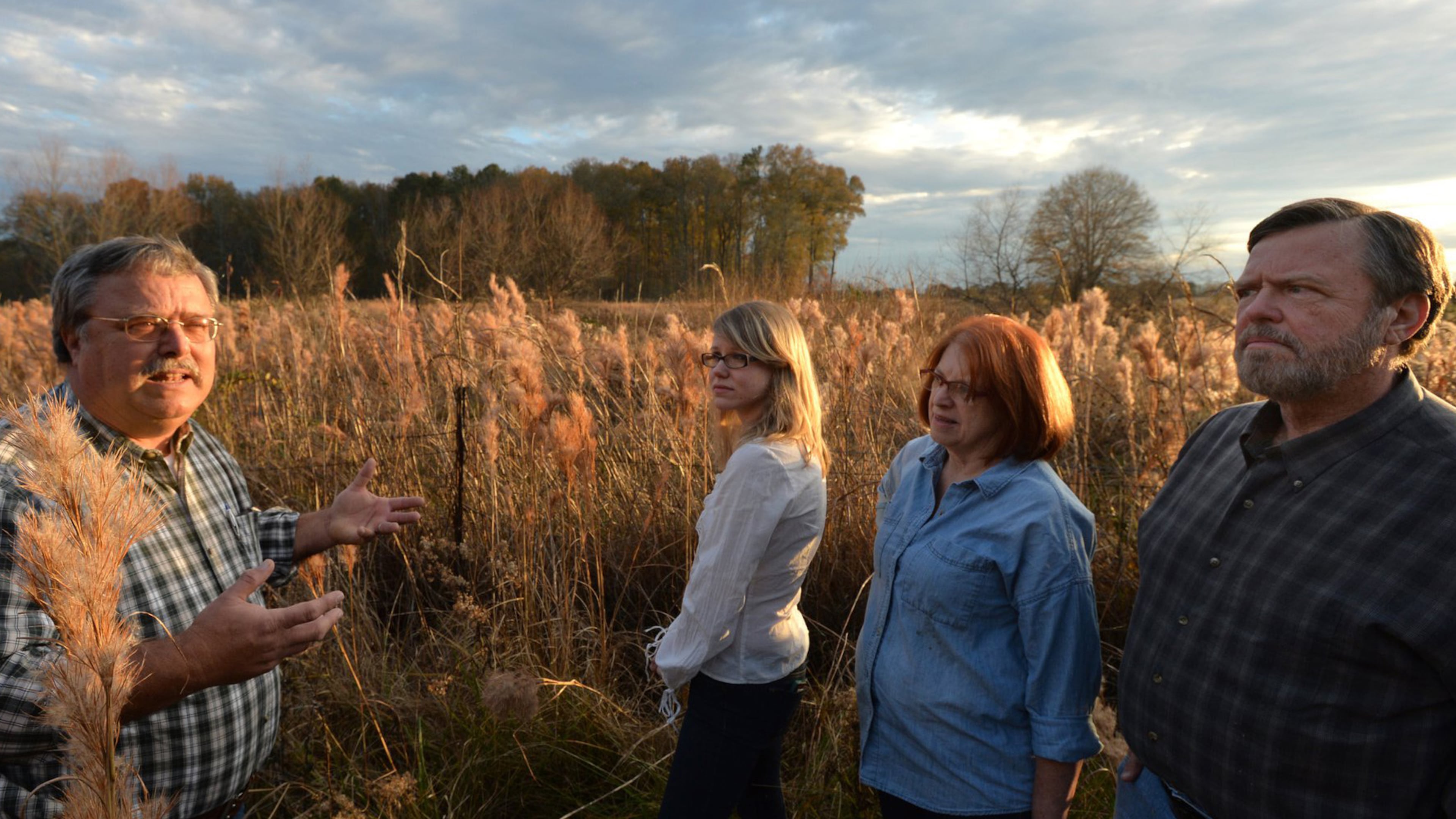 Jeff DeFoor (left) talks with his daughter Kaitlin DeFoor (second from left) and brother and his wife Dan and Mary DeFoor near his property and proposed pipeline route in Resaca. The line would help bring in gas from fracking fields in other parts of the nation. But DeFoor and his family fear a potential safety and environmental hazard.
