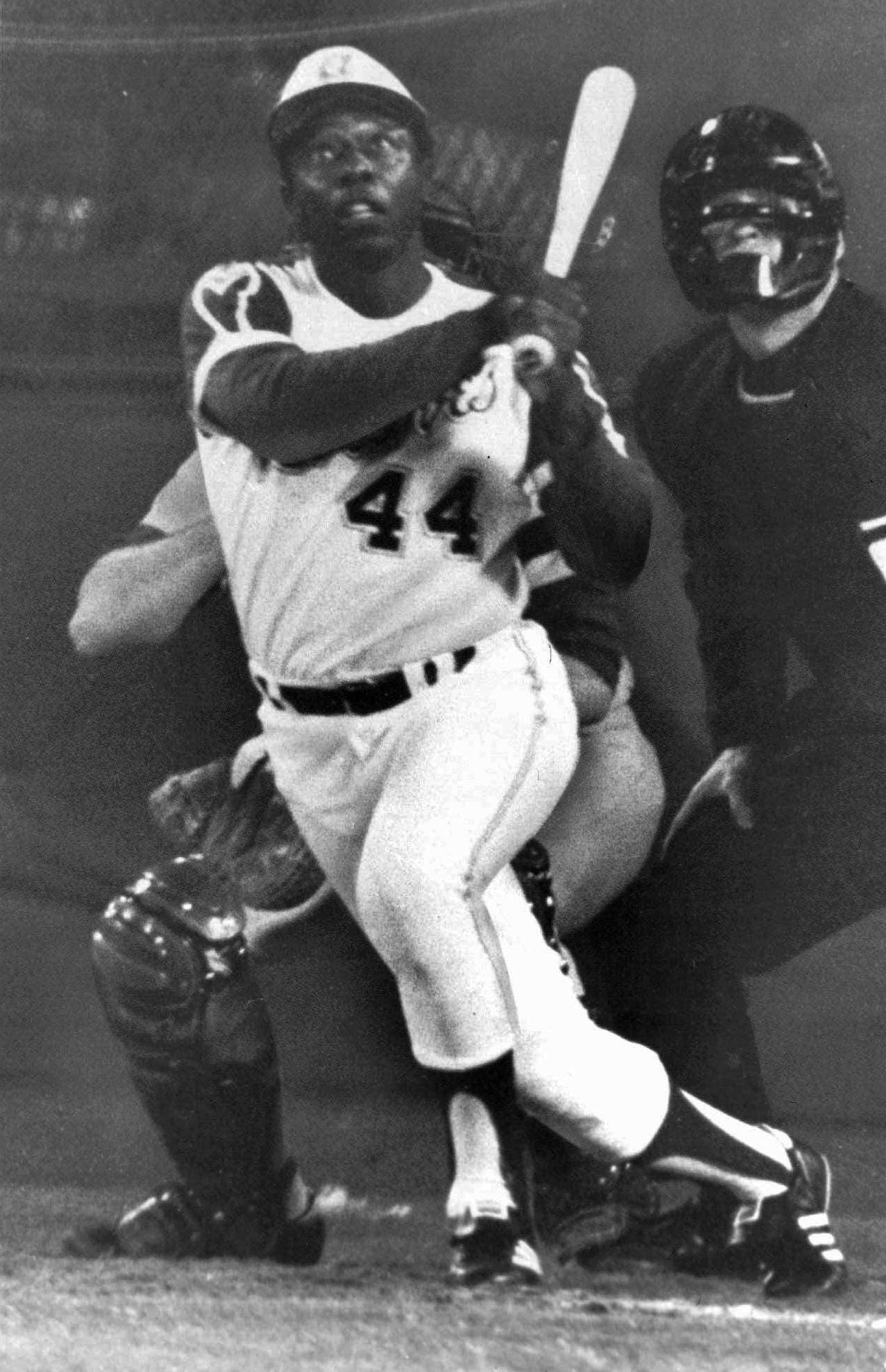 Hank Aaron, the umpire and the Dodgers catcher Joe Ferguson follow the flight of the ball as Aaron hits his 715th home run.