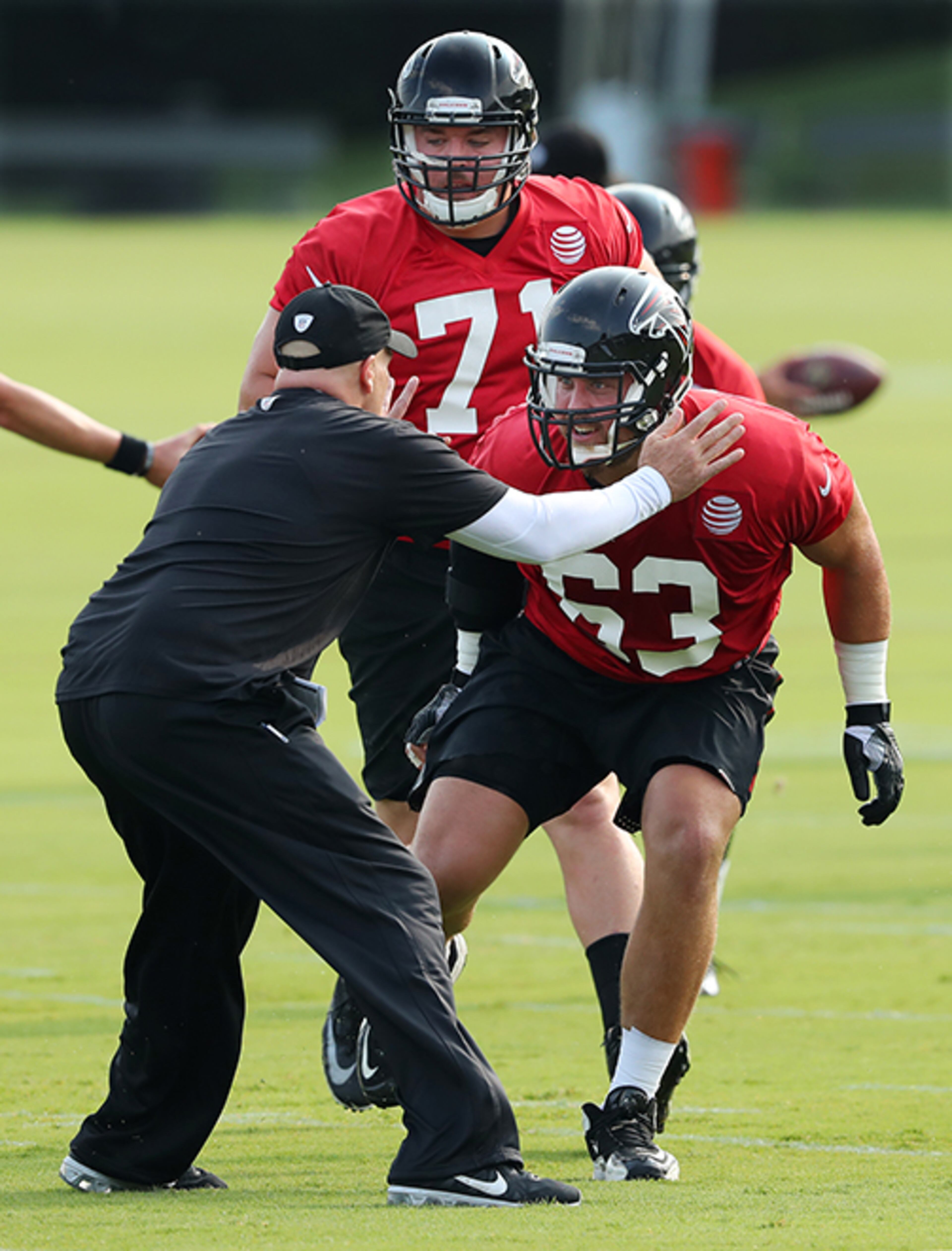 July 27, 2017 Flowery Branch: Falcons head coach Dan Quinn works with offensive guards Wes Schweitzer and Ben Garland (right) on the first day of team practice at training camp on Thursday, July 27, 2017, in Flowery Branch. Curtis Compton/ccompton@ajc.com