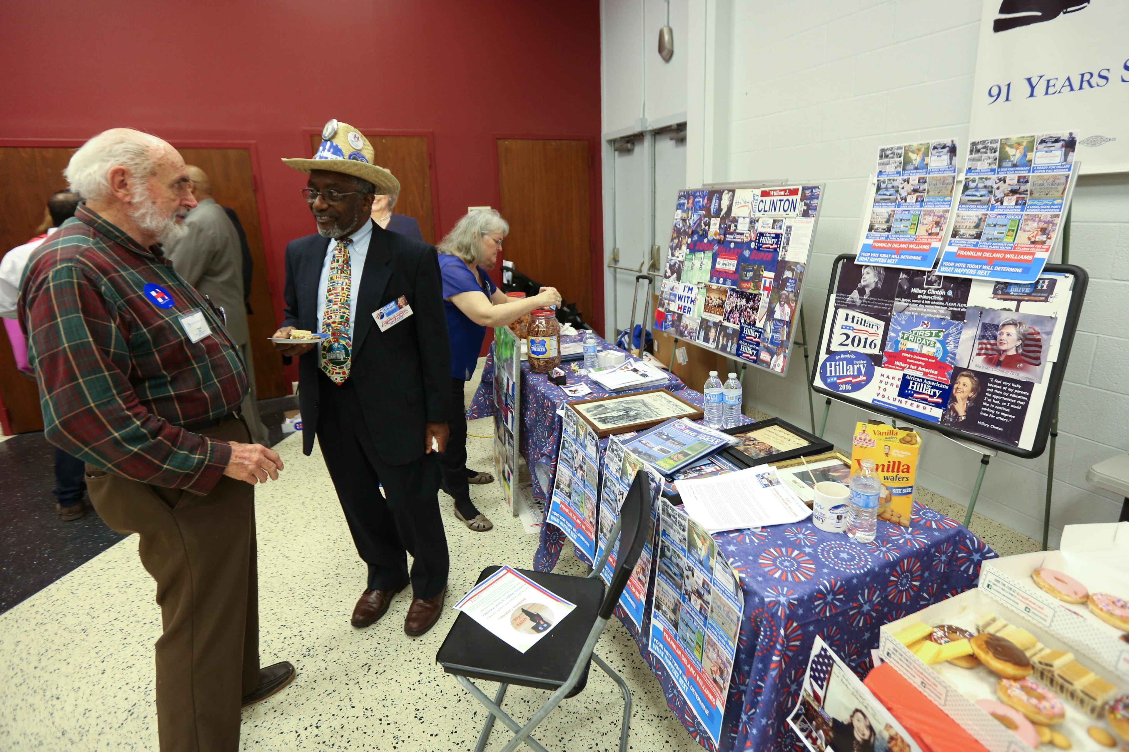 Franklin Delano Williams, center, who's running to be an at-large delegate for Democratic presidential candidate Hillary Clinton, talks with an unidentified man at the IBEW Local 613 Auditorium, Saturday, June 11, 2016, in Atlanta. Members of the Georgia Democratic Party gathered to elect at-large and alternate delegates to the Democratic National Convention in Philadelphia. BRANDEN CAMP/SPECIAL