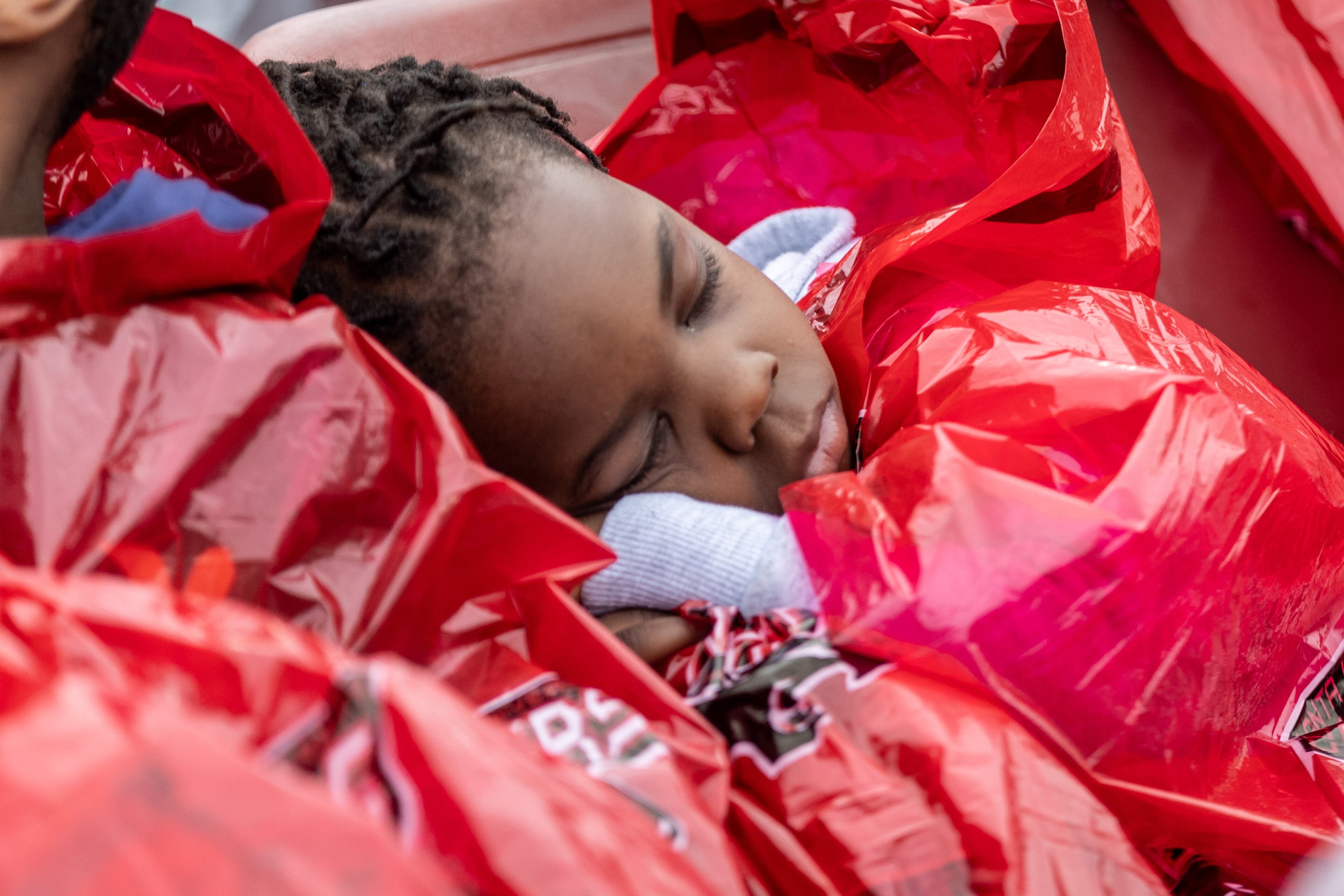People try to stay dry and warm before the start of the Clark Atlanta University commencement ceremony in Panther Stadium on Saturday, May 20, 2023. (Steve Schaefer / steve.schaefer@ajc.com)