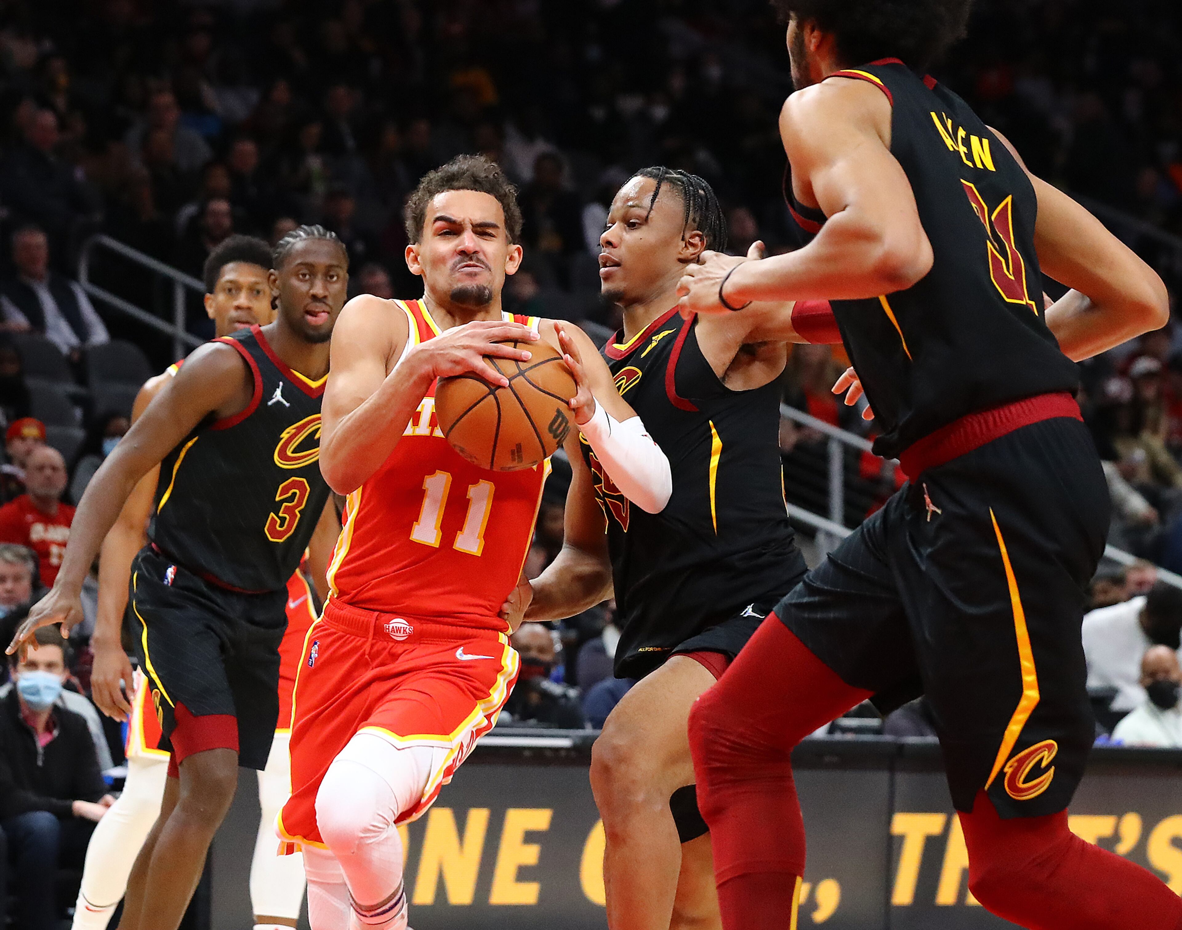 Hawks guard Trae Young goes strong for two of his 41 points through three Cleveland Cavaliers defenders in a NBA basketball game on Tuesday, Feb. 15, 2022, in Atlanta. The Hawks won. “Curtis Compton / Curtis.Compton@ajc.com”`
