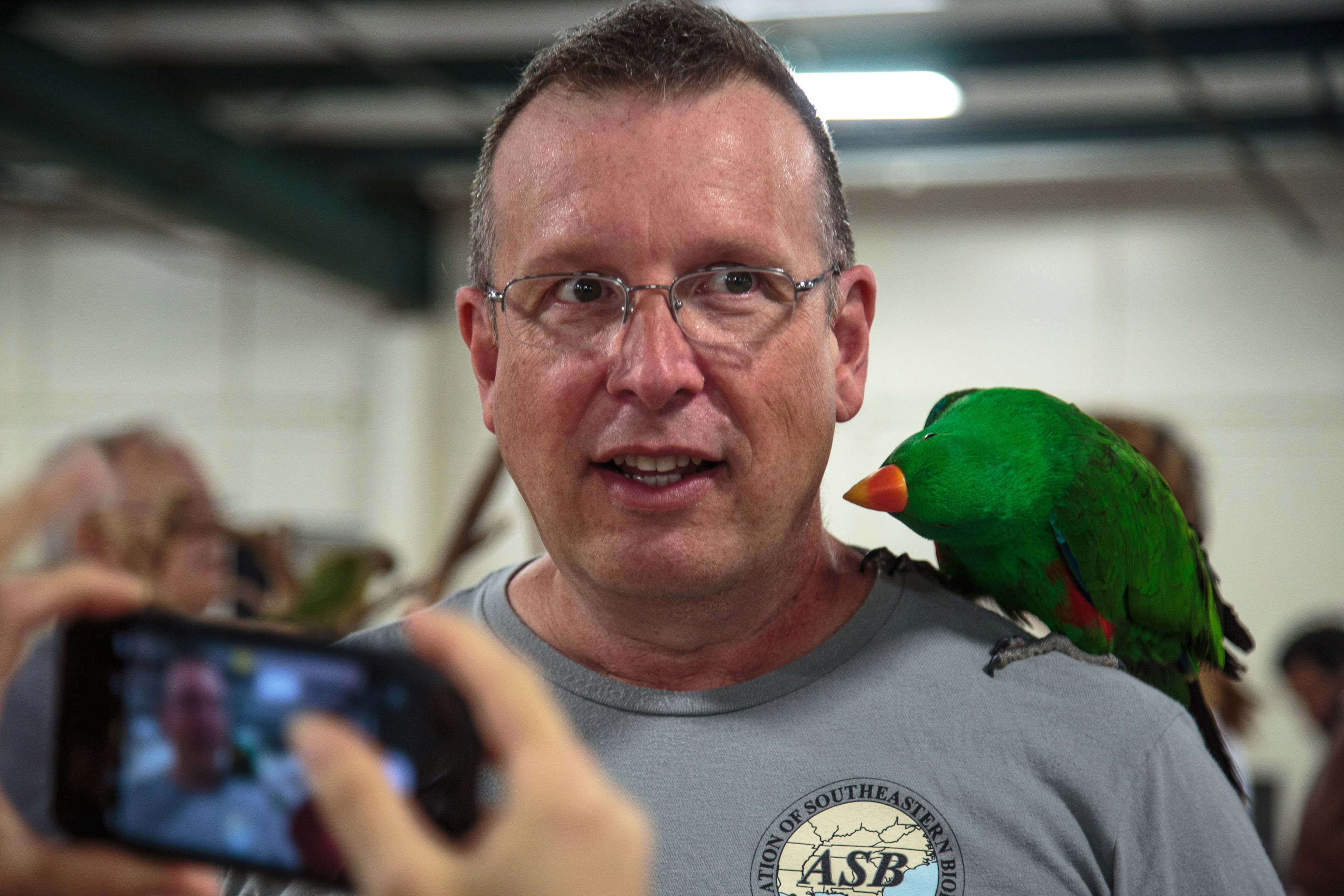 Ricky Fiorillo is not so sure about having a bird on his shoulder while he gets his photograph taken during the Southeast Exotic Bird Fair at the Gwinnett County Fairgrounds in Lawrenceville GA Sunday, July 8, 2018. STEVE SCHAEFER / SPECIAL TO THE AJC
