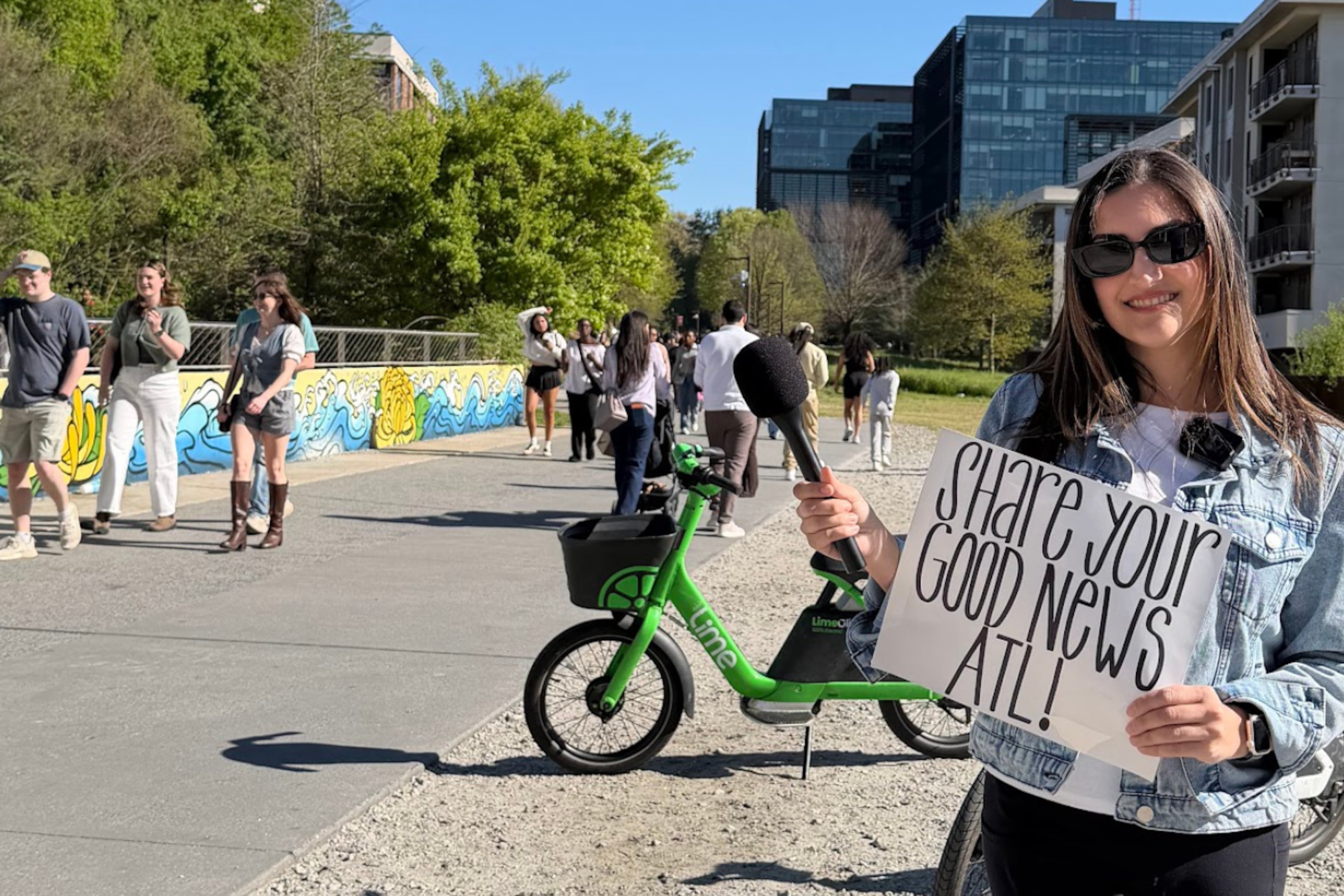 Atlanta native Catherine Catoura invites pedestrians along the Beltline to share their goods news. (Courtesy of Catherine Catoura)