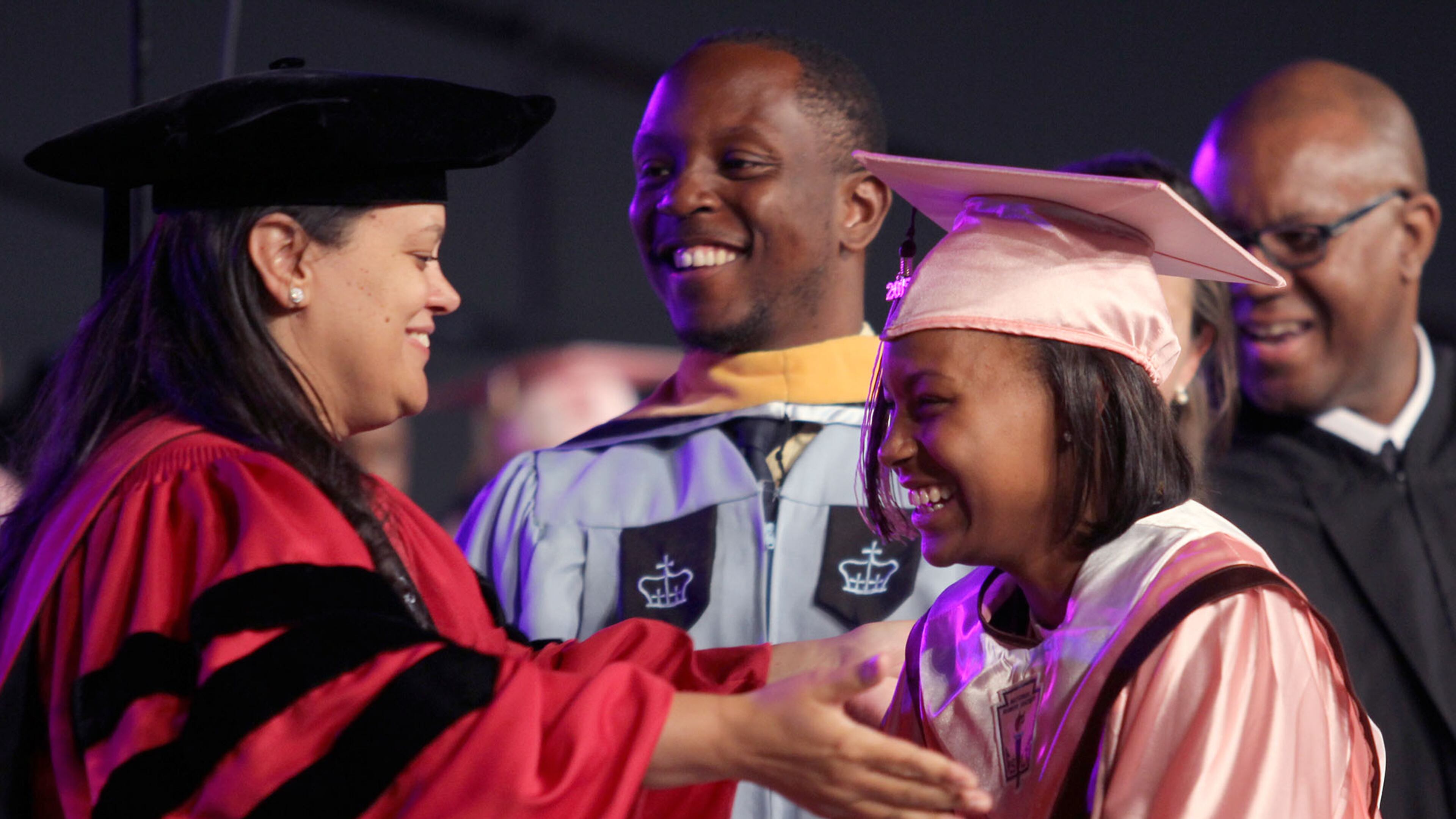 Atlanta Public School Superintendent Meria Carstarphen offers a hug to a student as she receives her diploma at the commencement ceremony for the Coretta Scott King Young Women's Academy High School and The Business Engineering Science and Technology (BEST) Academy at Benjamin S. Carson in 2015. (Akili-Casundria Ramsess/Special to the AJC)